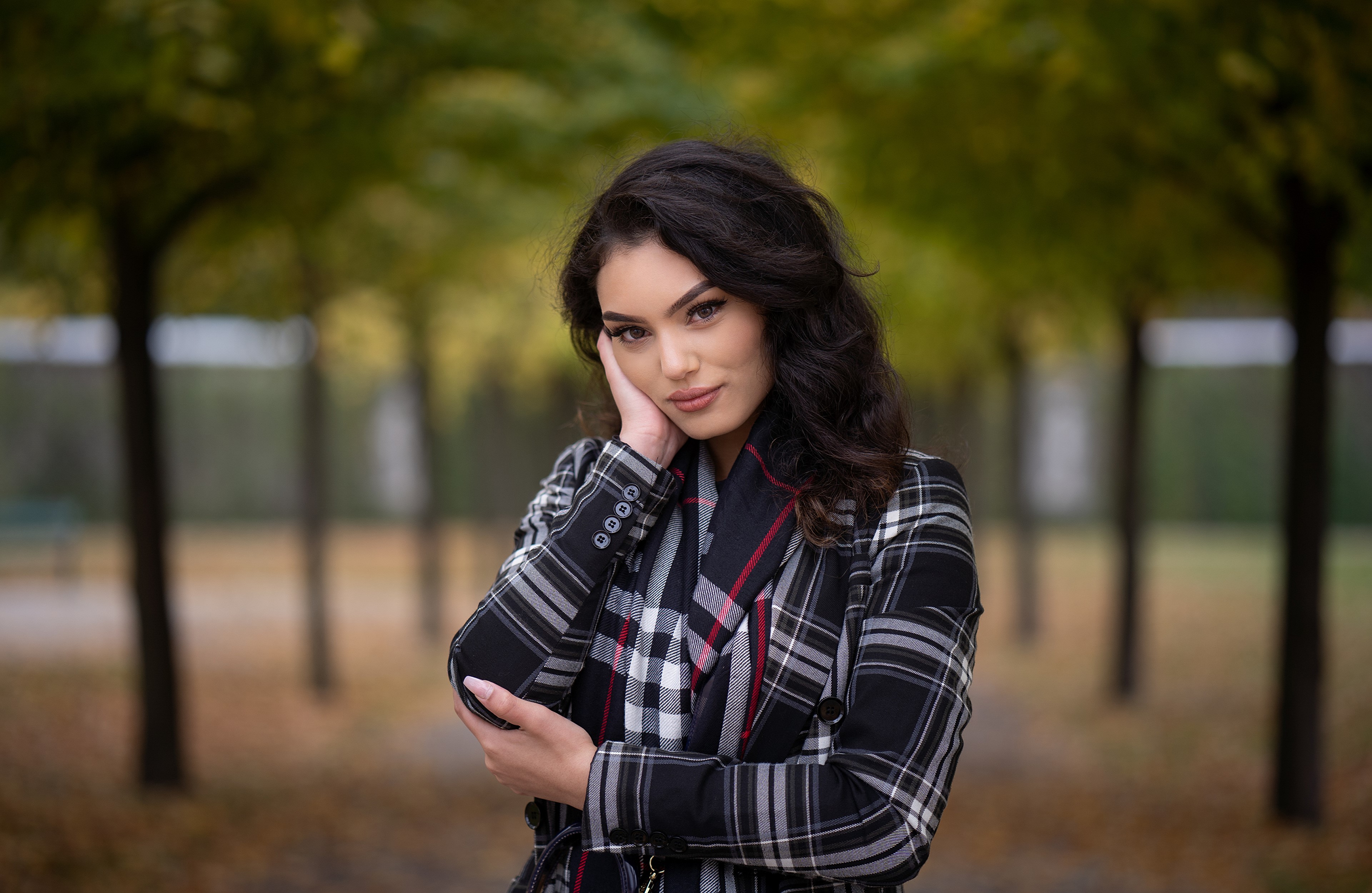 Brunette girl in plaid coat posing outdoors HD Wallpaper