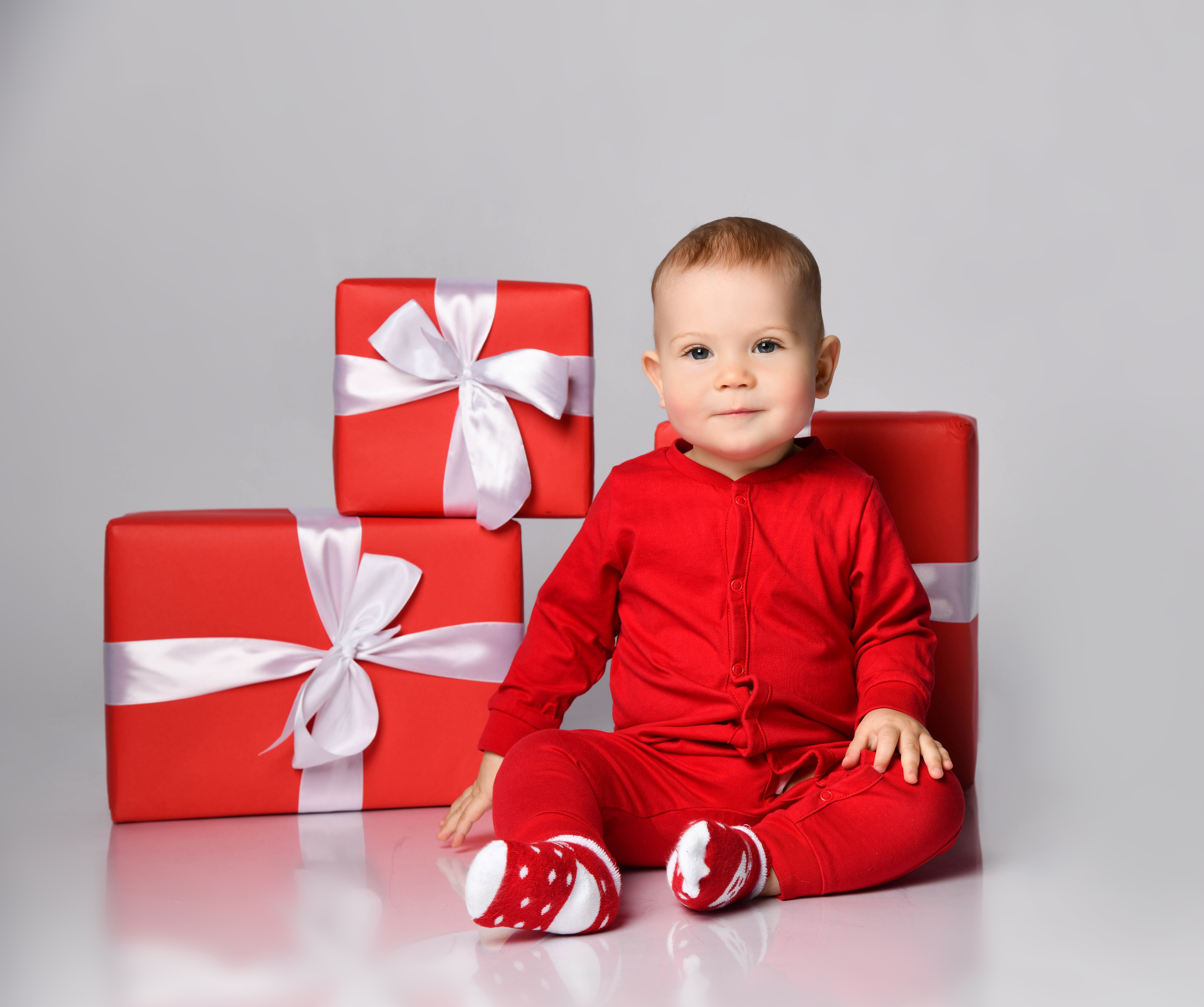 Baby in red pajamas with Christmas gifts HD Wallpaper