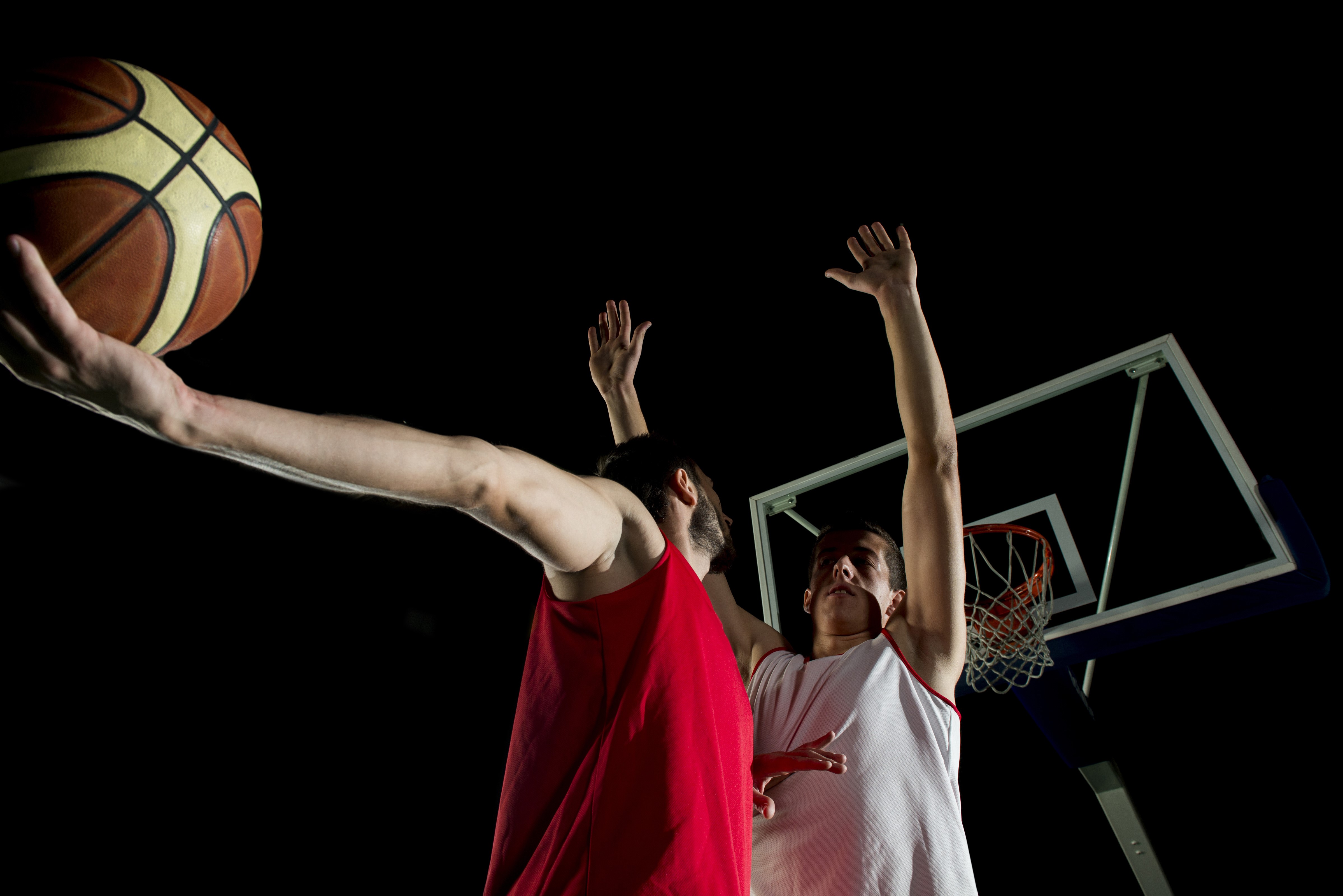 Two men playing basketball with a ball HD Wallpaper