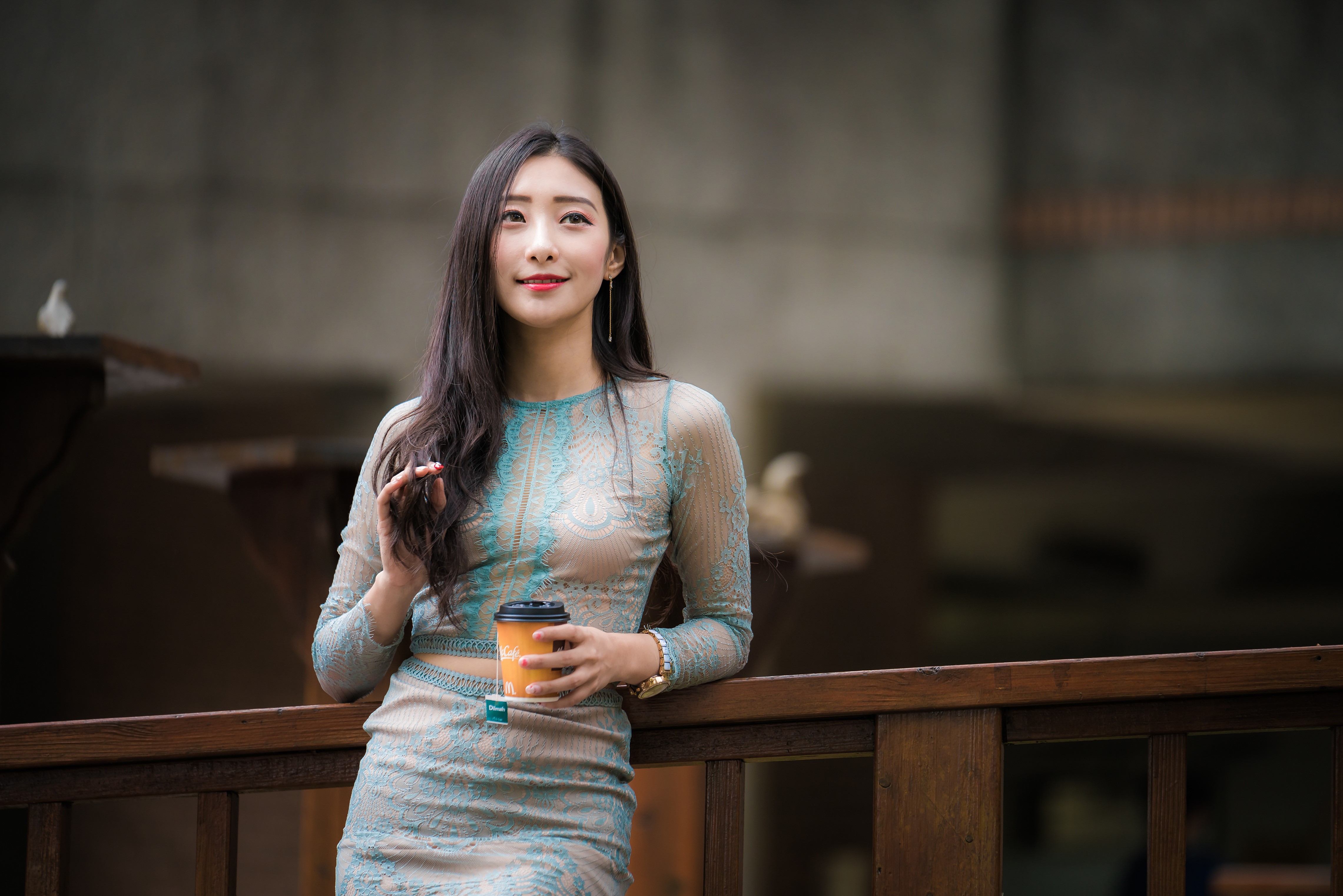 Asian woman holding a cup of tea HD Wallpaper