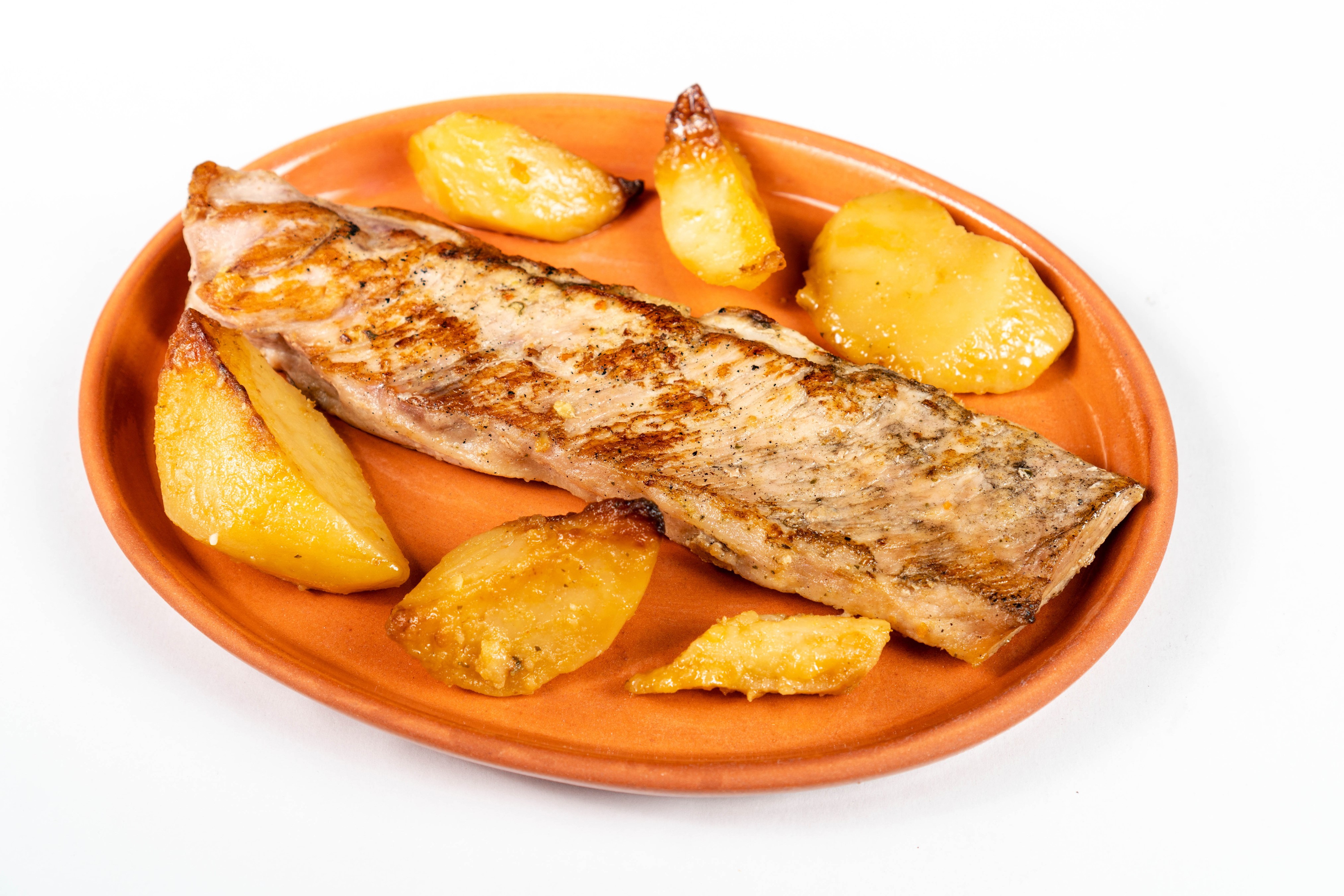 Grilled fish fillet with roasted potatoes on a plate HD Wallpaper