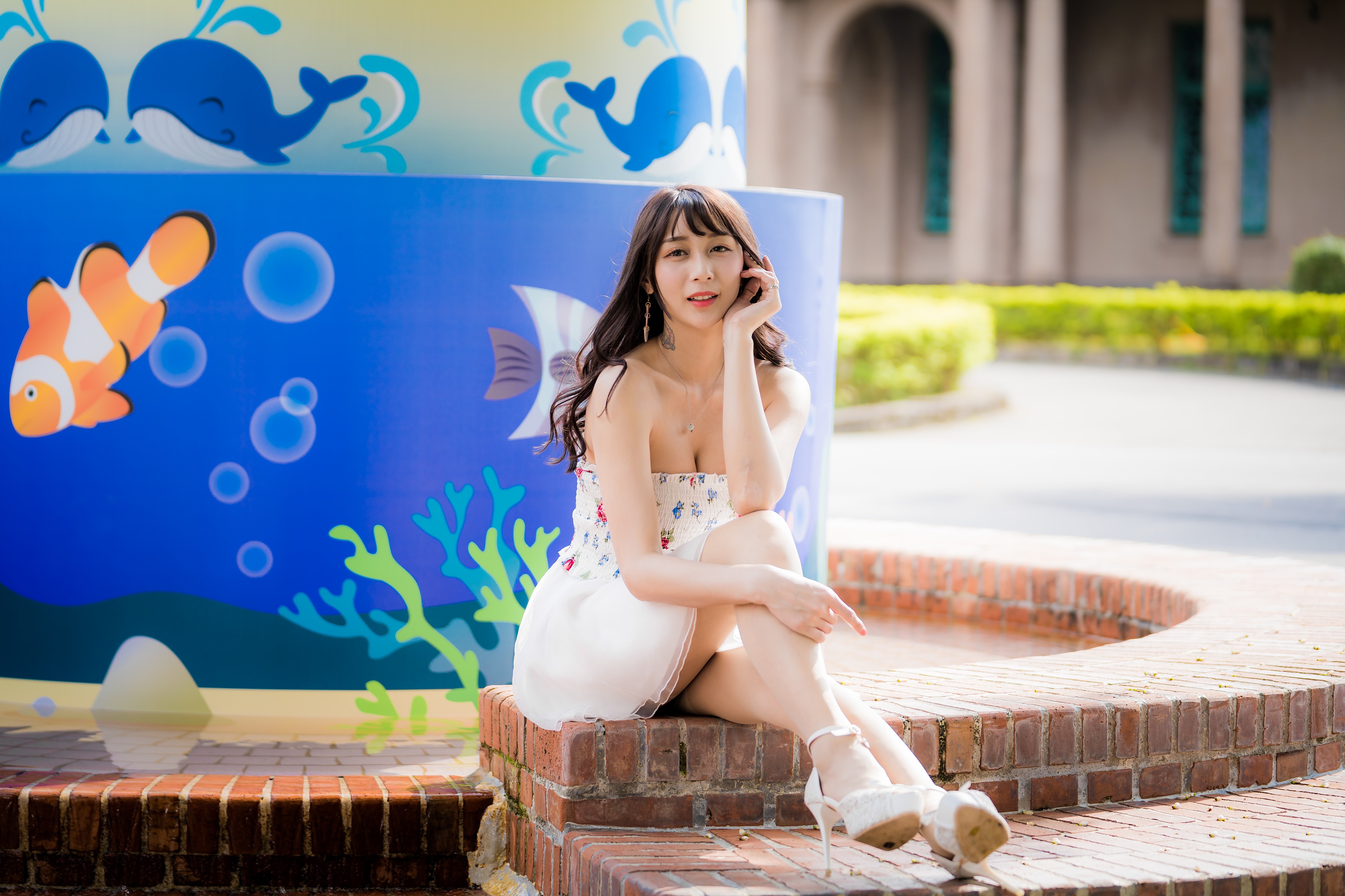 4K Asian Woman Sitting by Colorful Mural HD Wallpaper