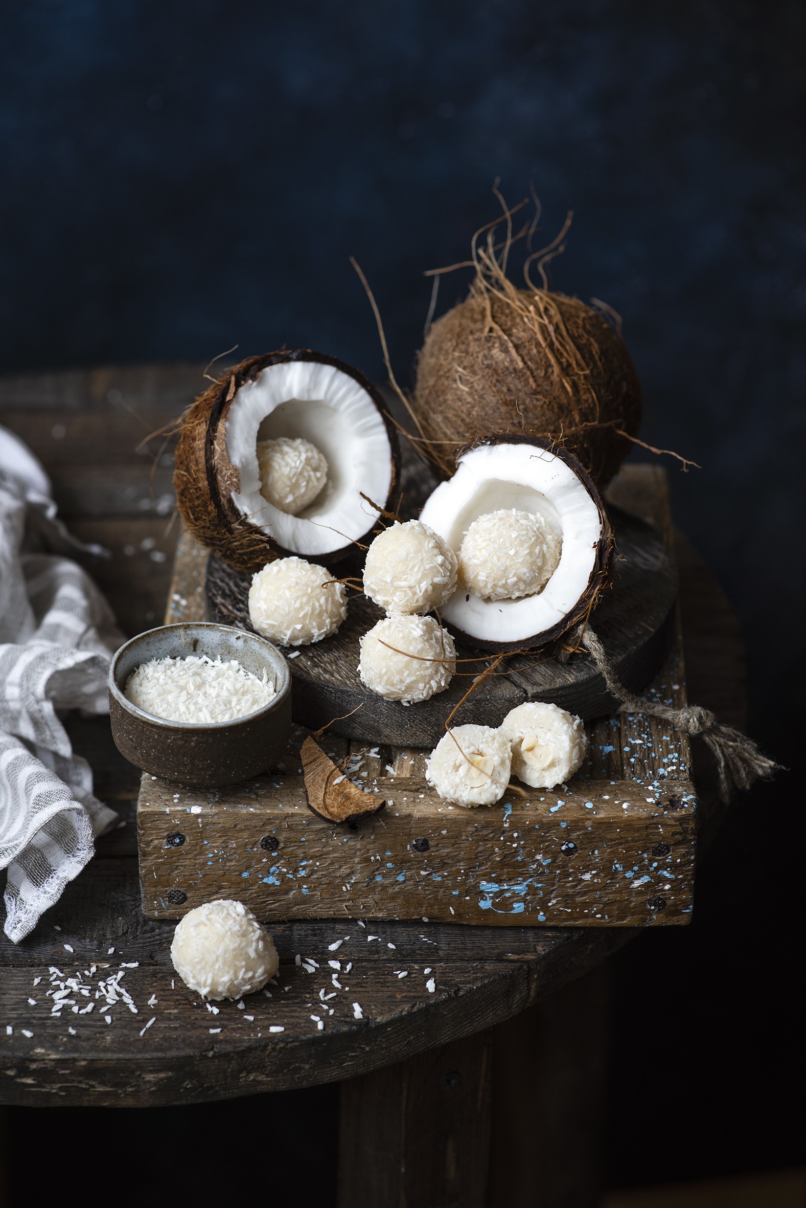 Coconut candies and coconuts on a wooden table HD Phone Wallpaper