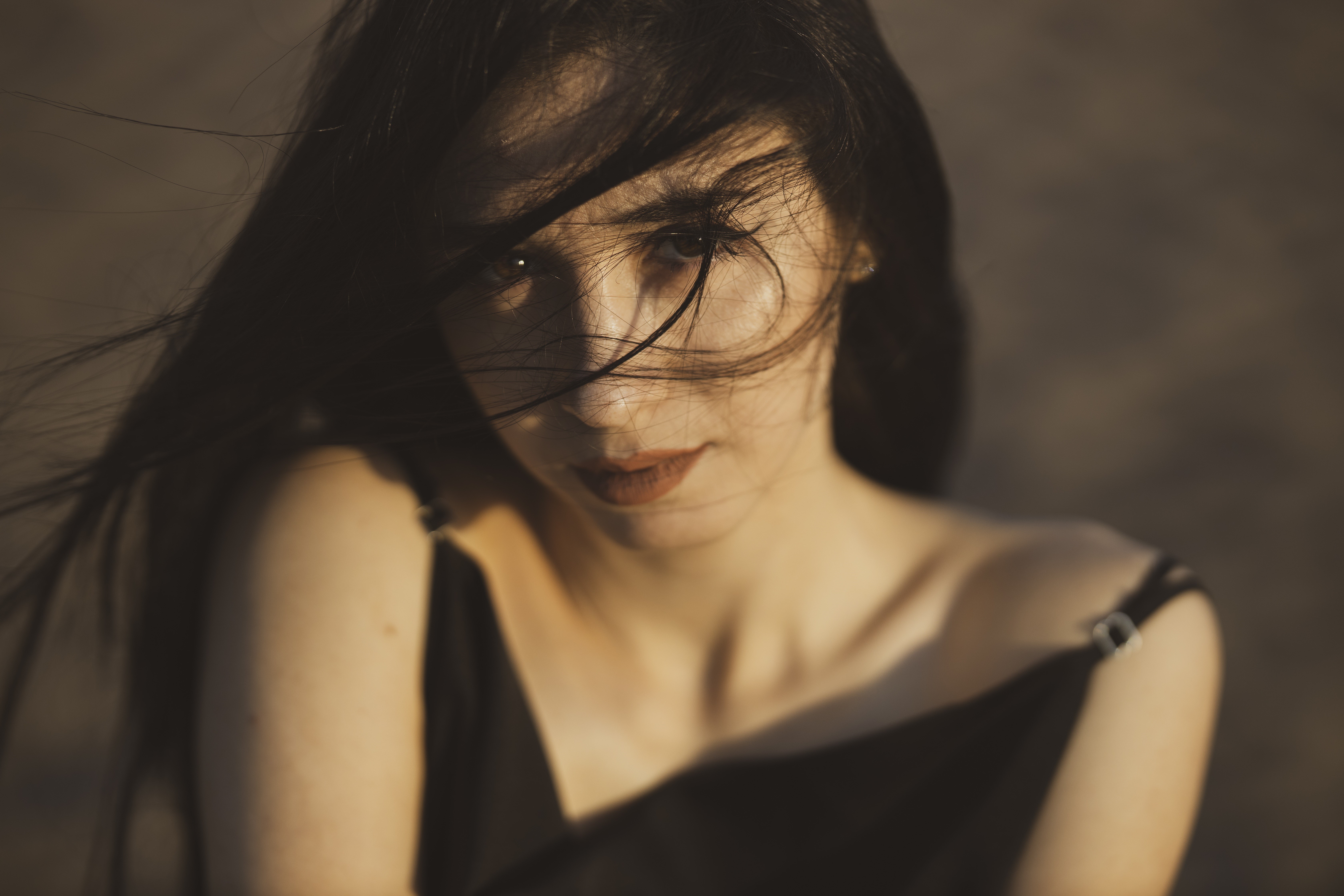 Brunette girl with hair blowing in the wind HD Wallpaper
