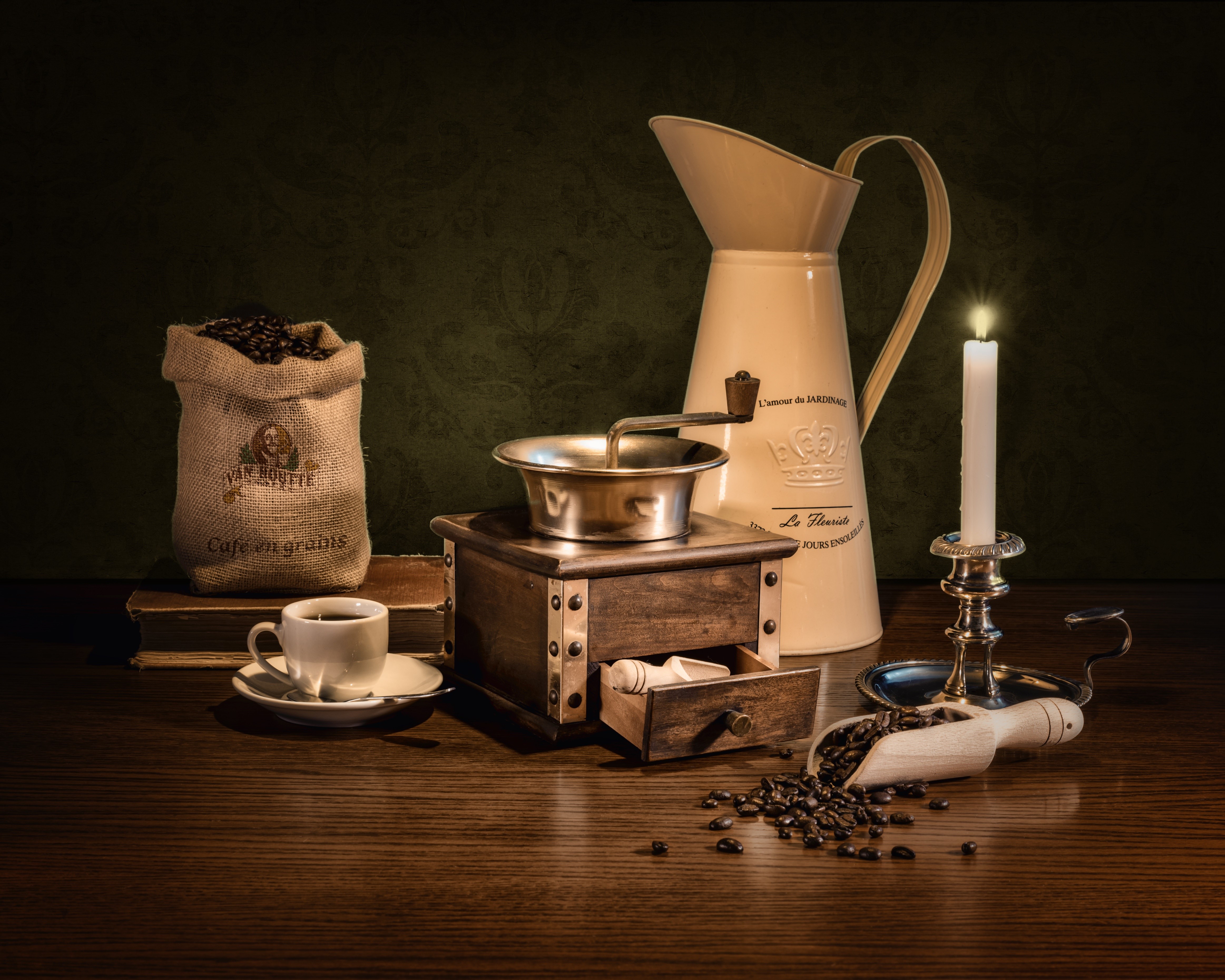 Coffee beans, cup, grinder, jug, and candle on table HD Wallpaper