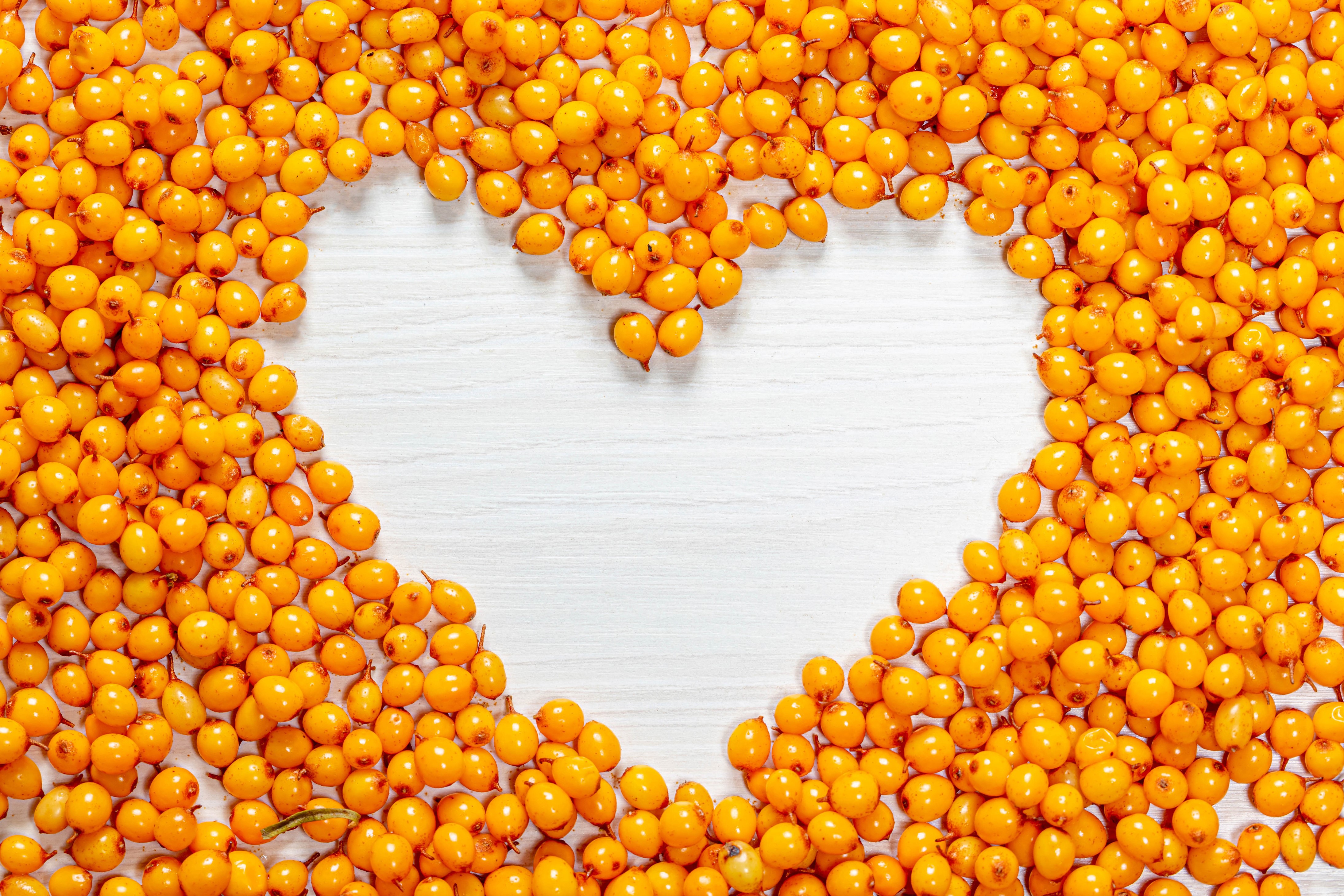 4K Sea-buckthorn berries in a heart shape HD Wallpaper