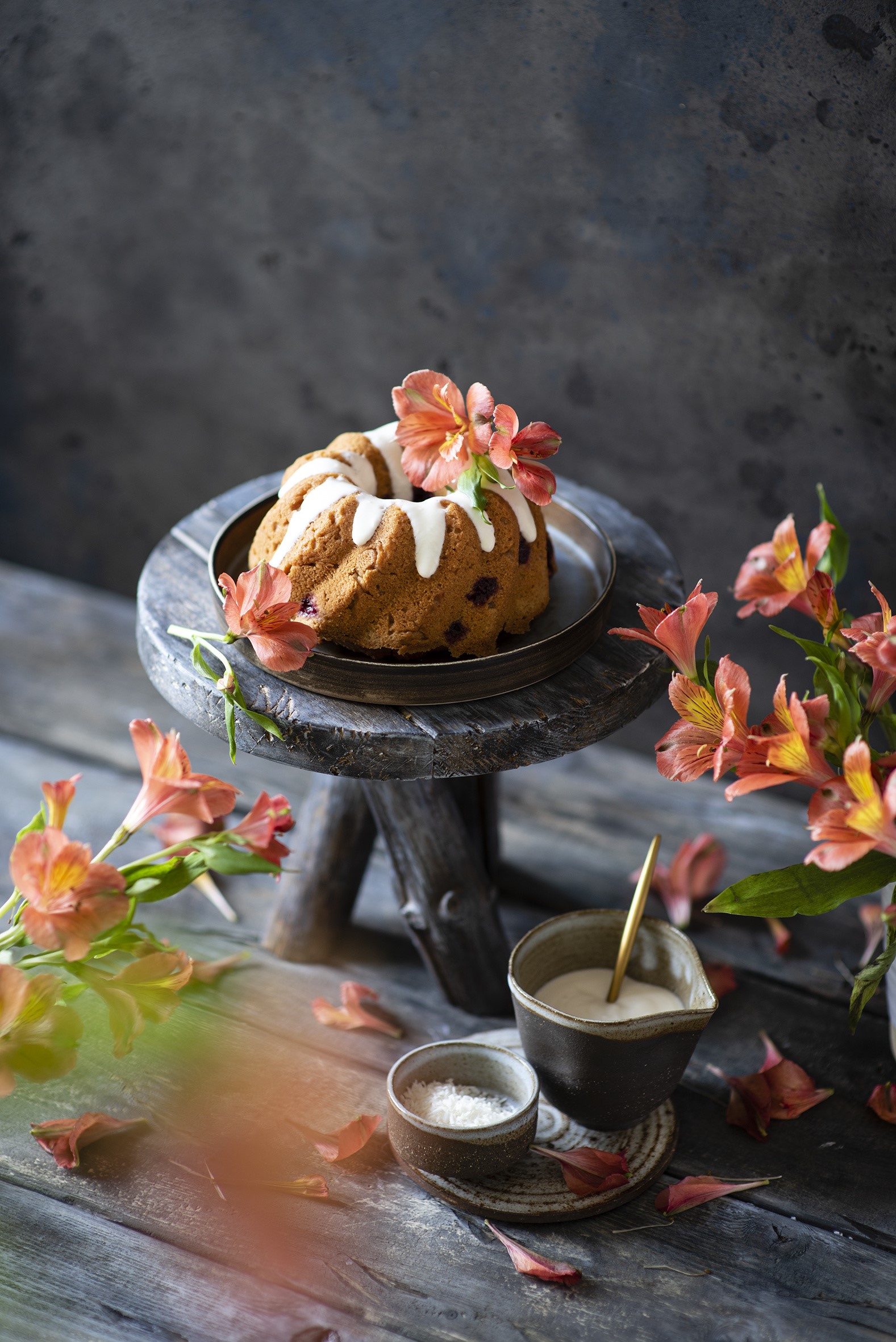 Bundt cake with icing and alstroemeria flowers HD Phone Wallpaper