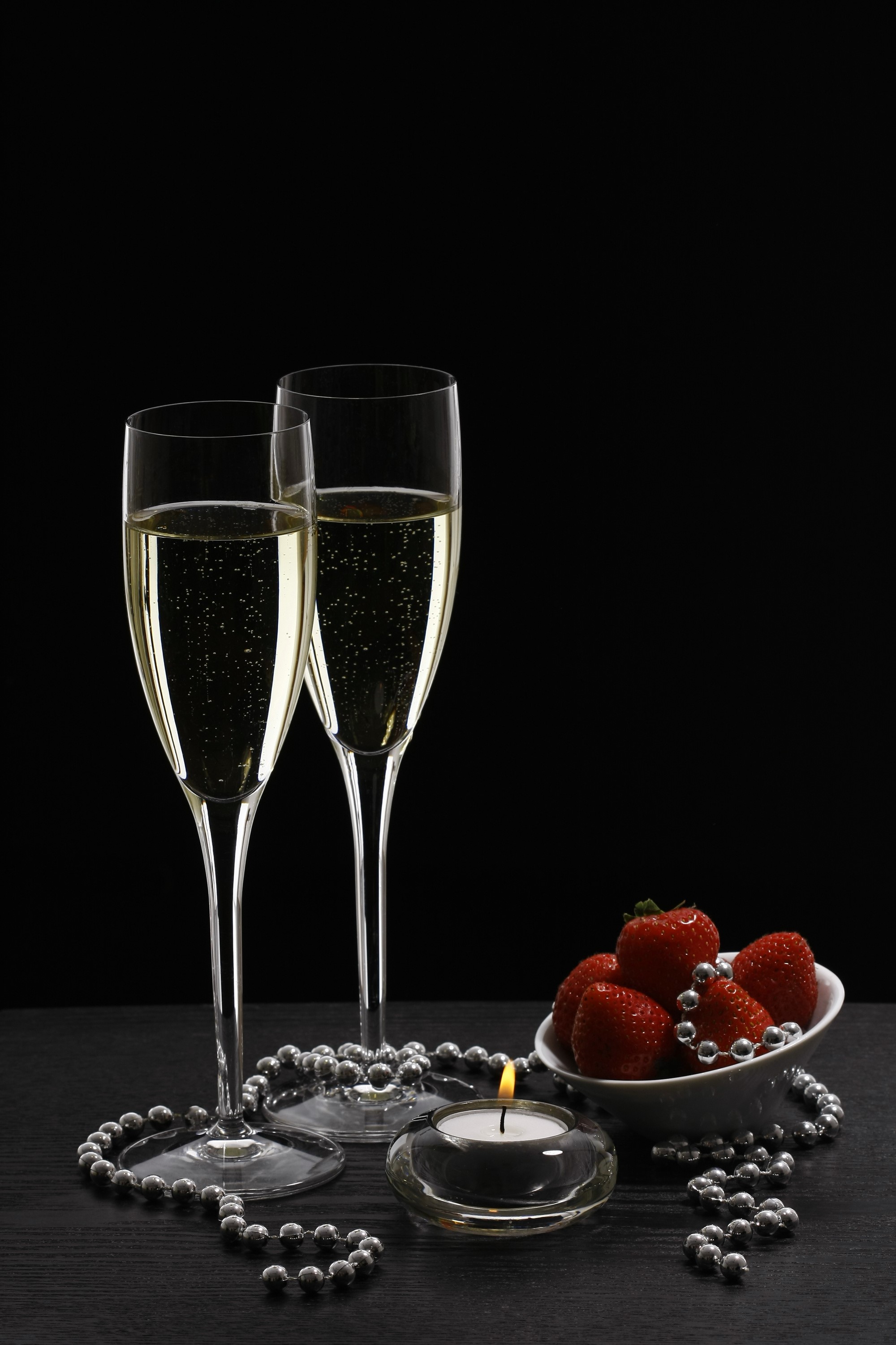 Champagne glasses with strawberries and candle HD Phone Wallpaper