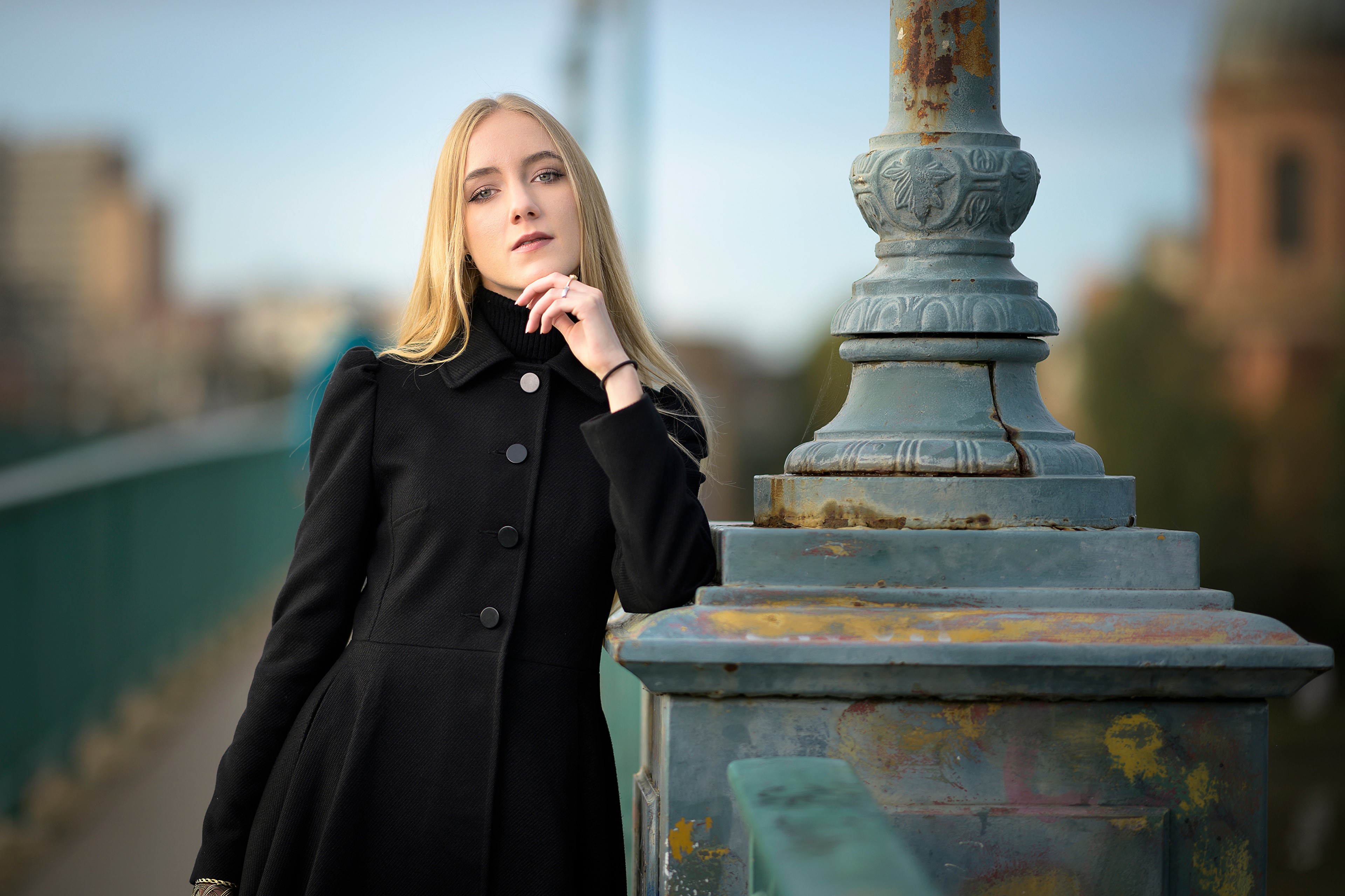 Blonde woman in black coat by lamppost HD Wallpaper