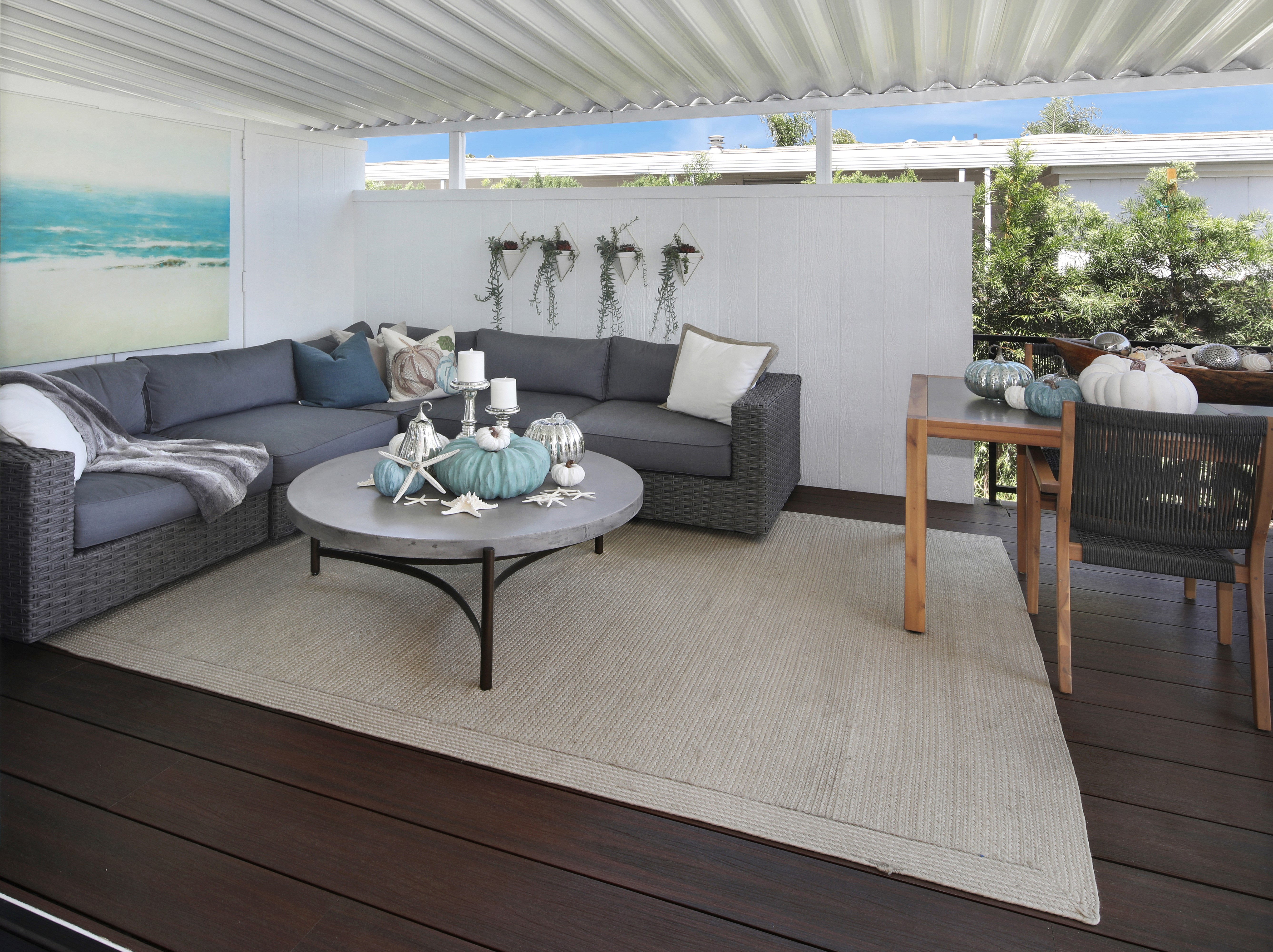 Outdoor living room with sectional sofa and coffee table HD Wallpaper