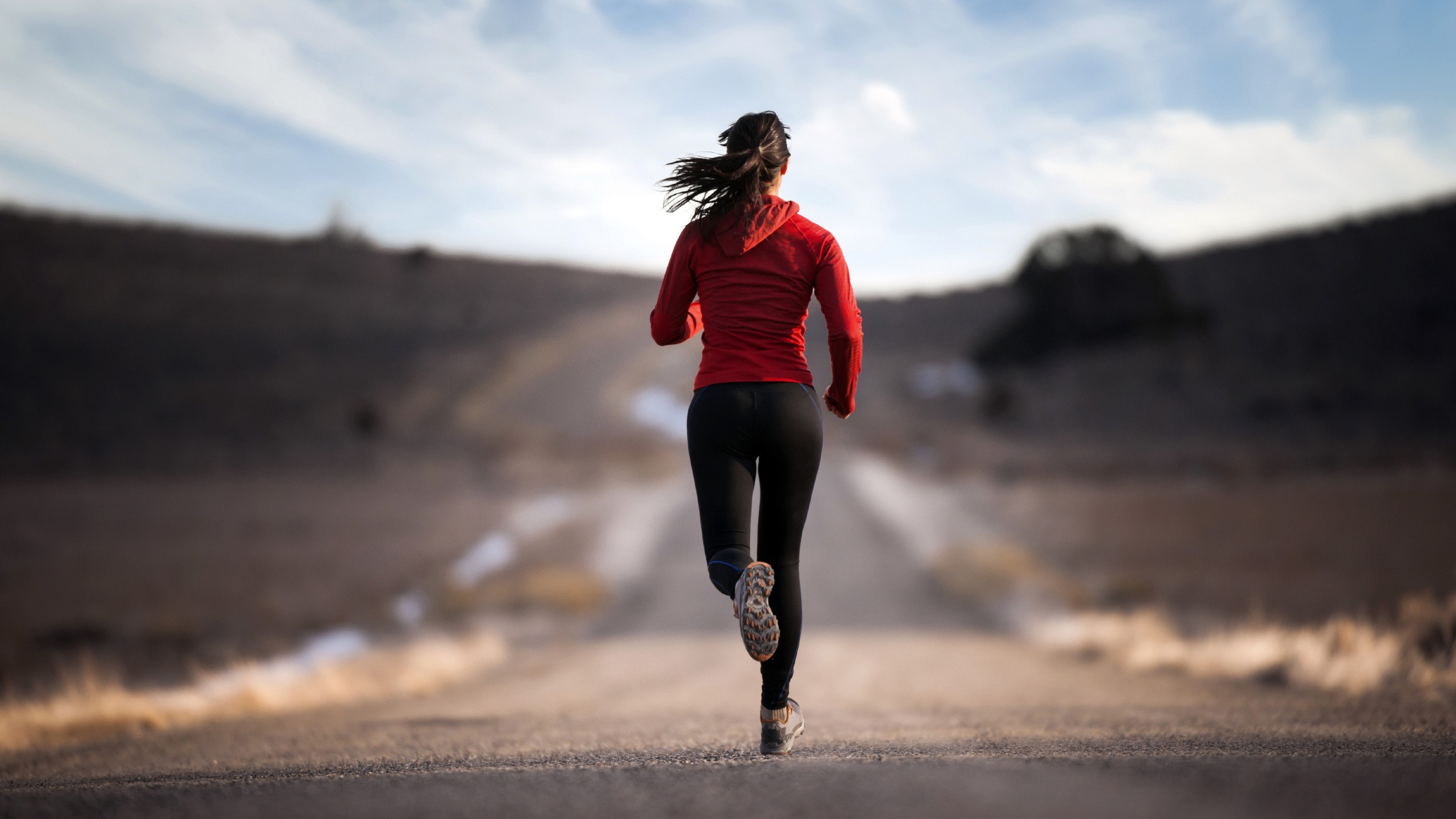 Woman running on a dirt road HD Wallpaper