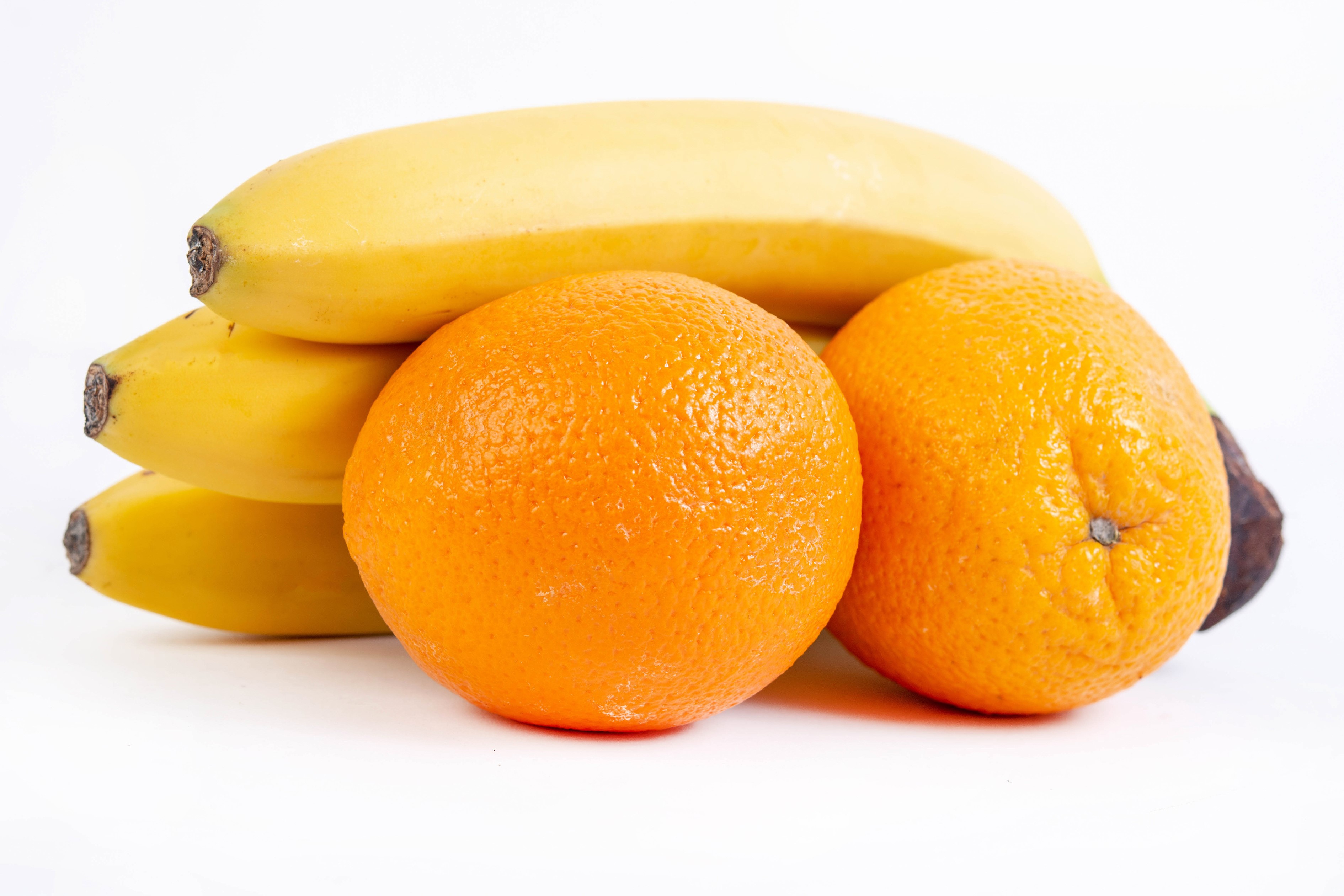 Bananas and oranges on a white background HD Wallpaper