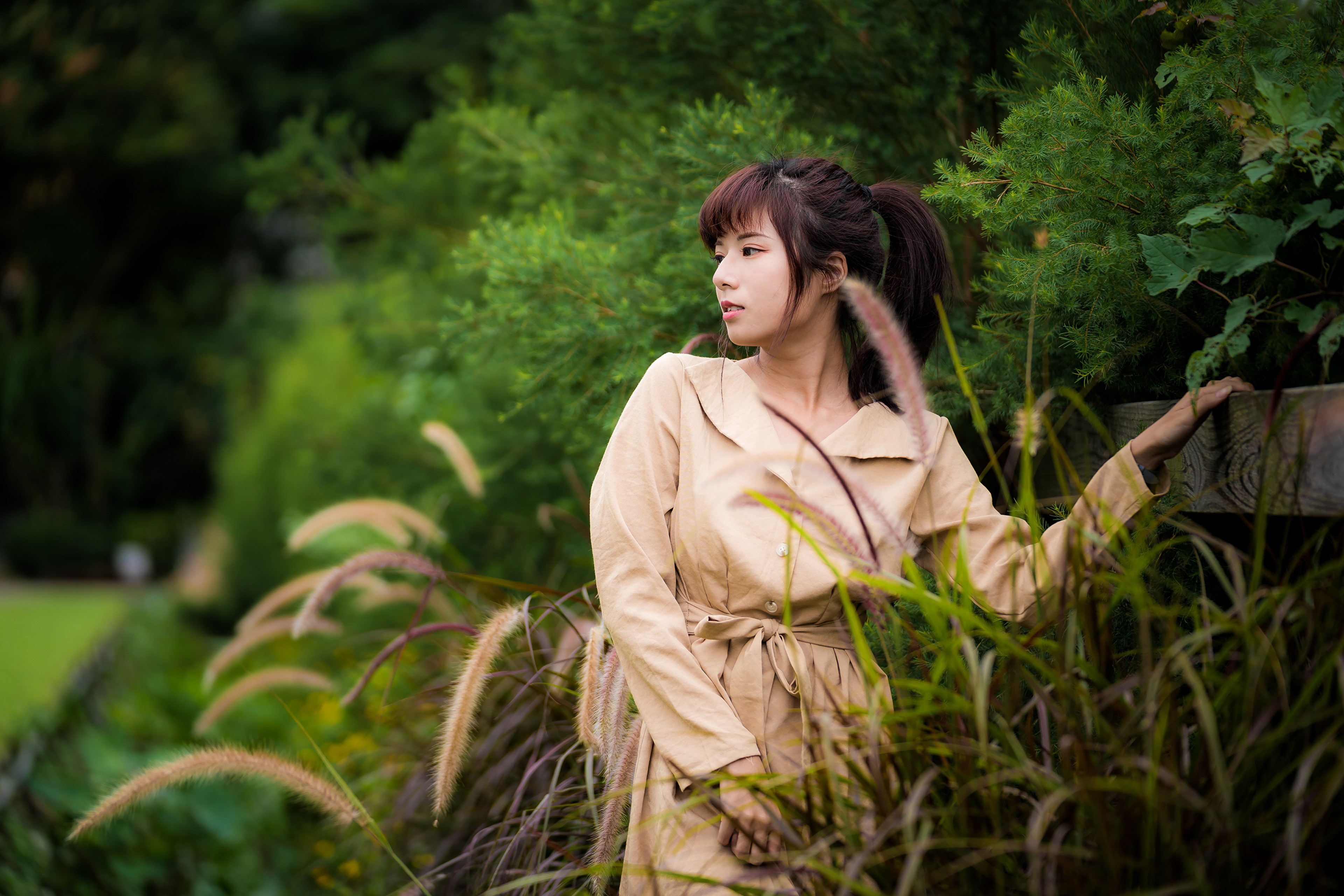 Asian woman in a tan cloak in a garden HD Wallpaper