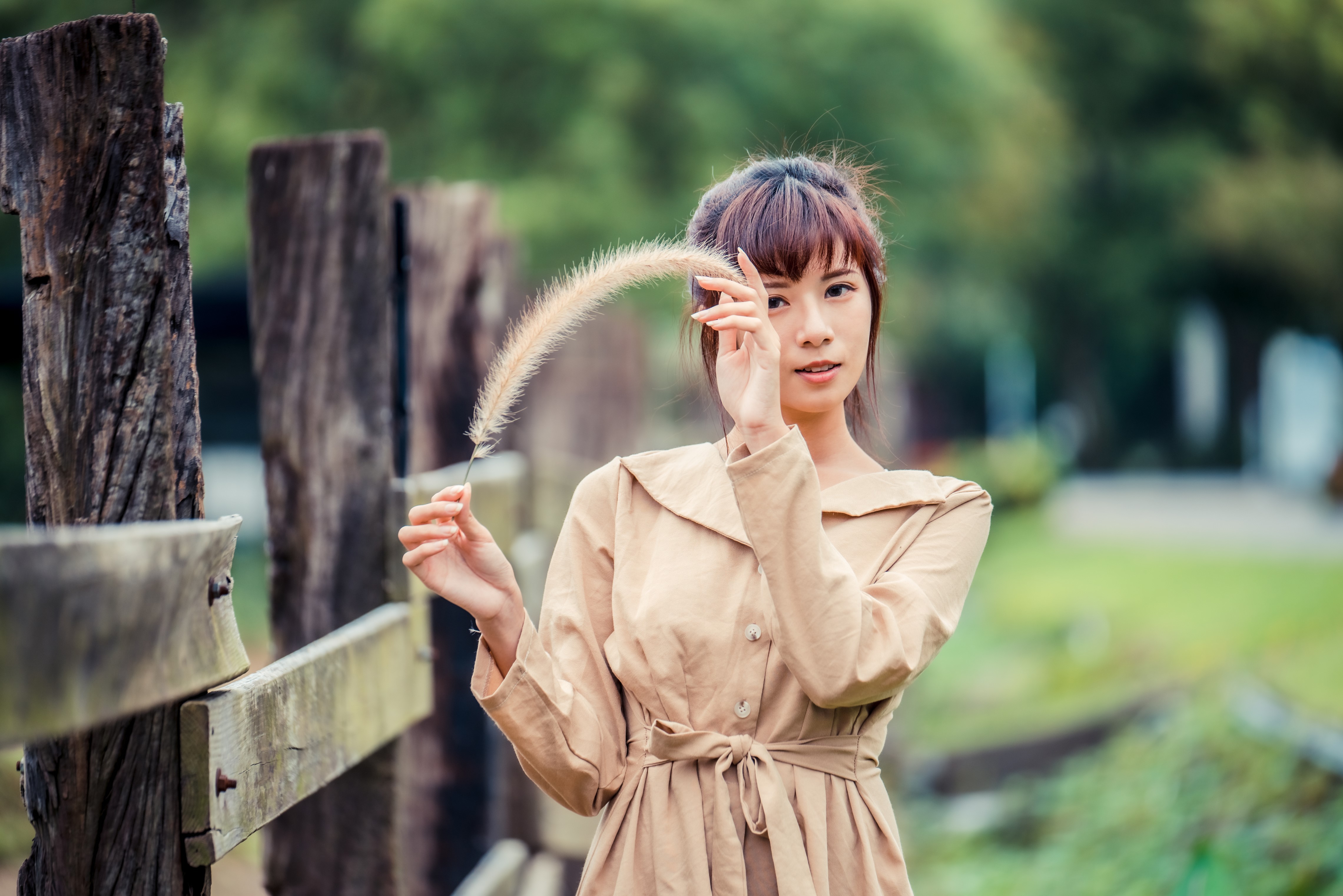 4K Asian Woman Holding Feather Outdoors HD Wallpaper