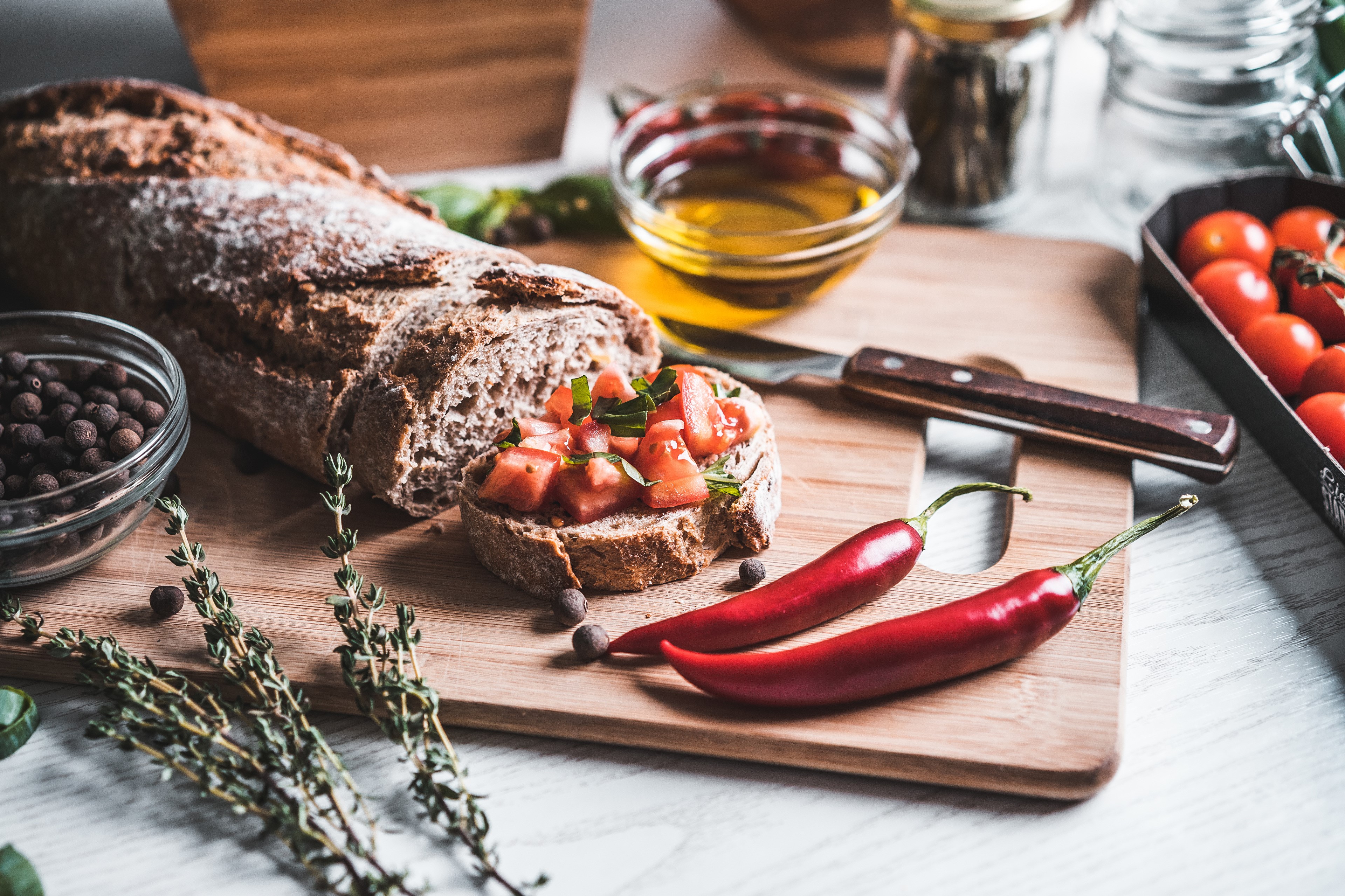 Bread with tomatoes and chili peppers on a cutting board HD Wallpaper