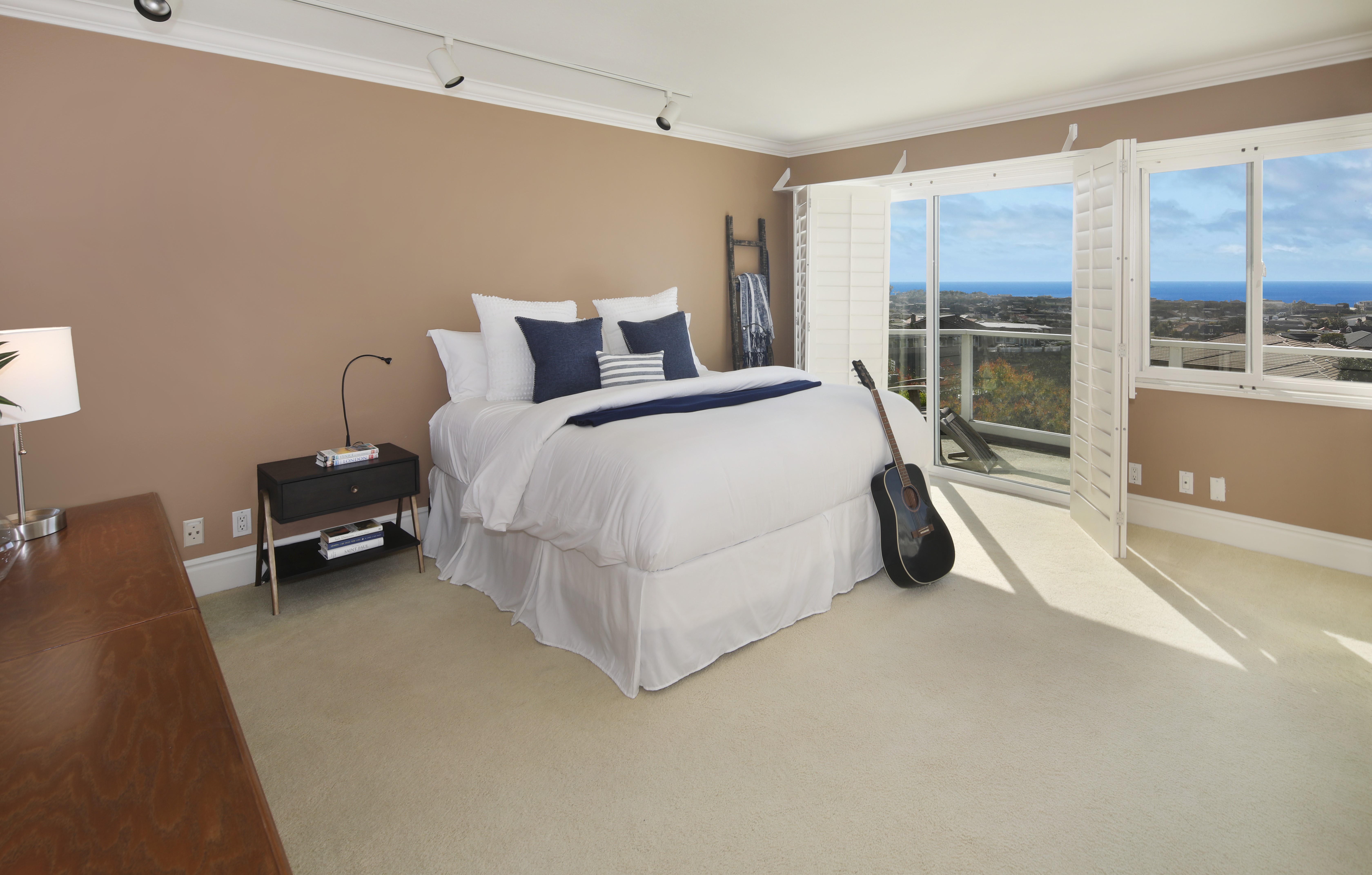 Bedroom with bed, guitar, and ocean view HD Wallpaper