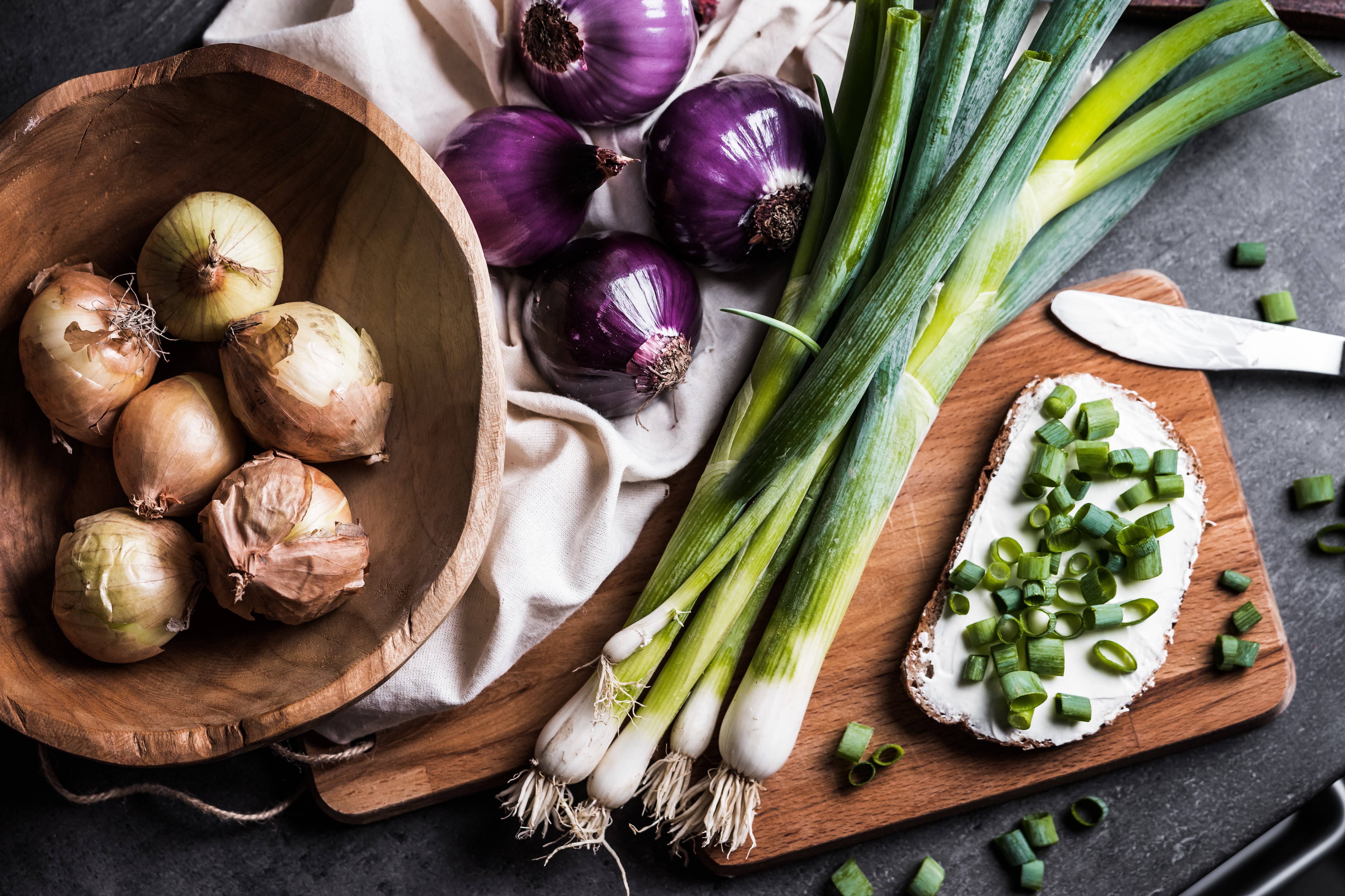 Onions, Scallions, and Bread with Butter on Cutting Board HD Wallpaper