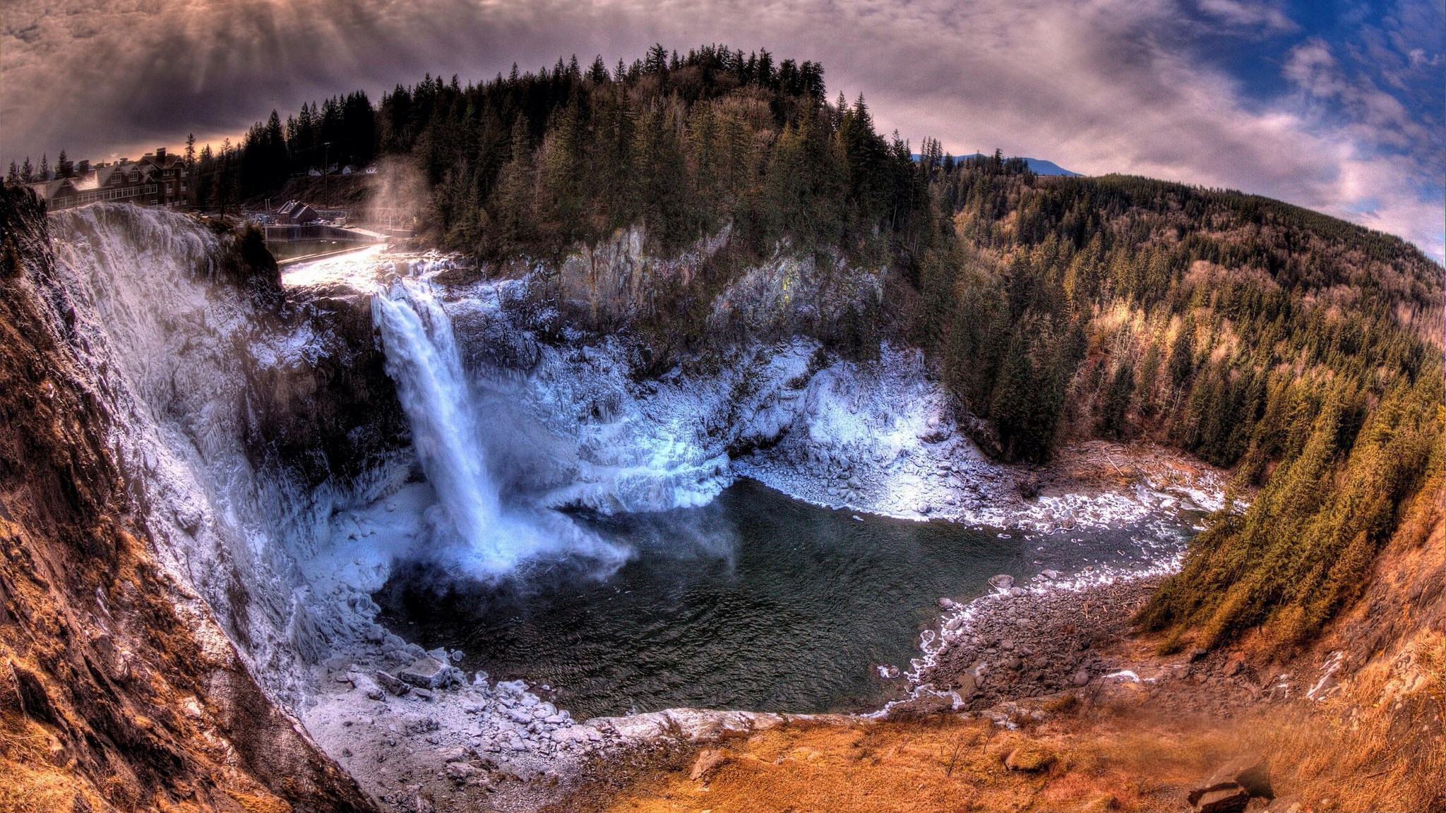 Waterfall cascading into a pool surrounded by trees and snow HD Wallpaper