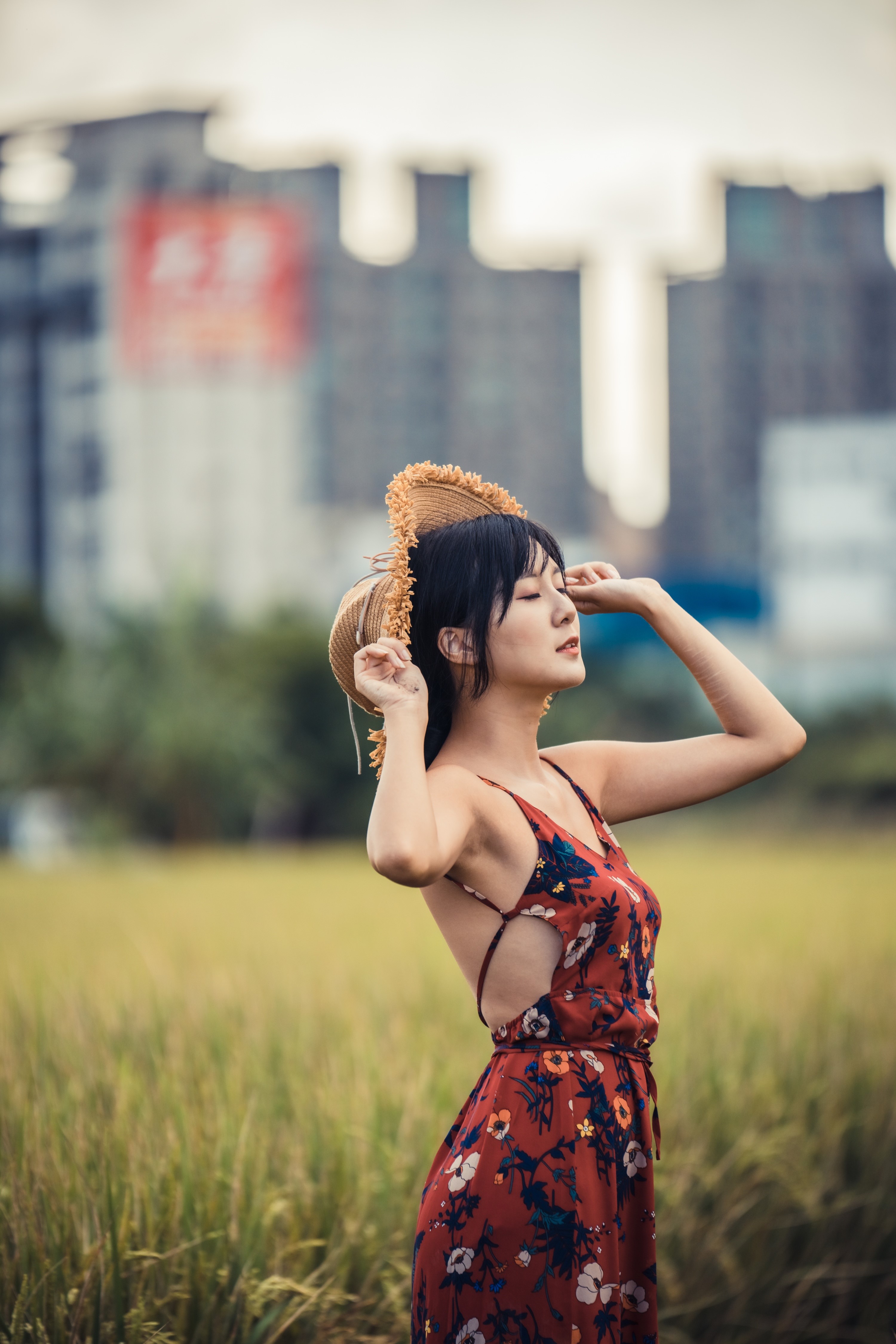 Woman in a floral dress holding a straw hat HD Phone Wallpaper