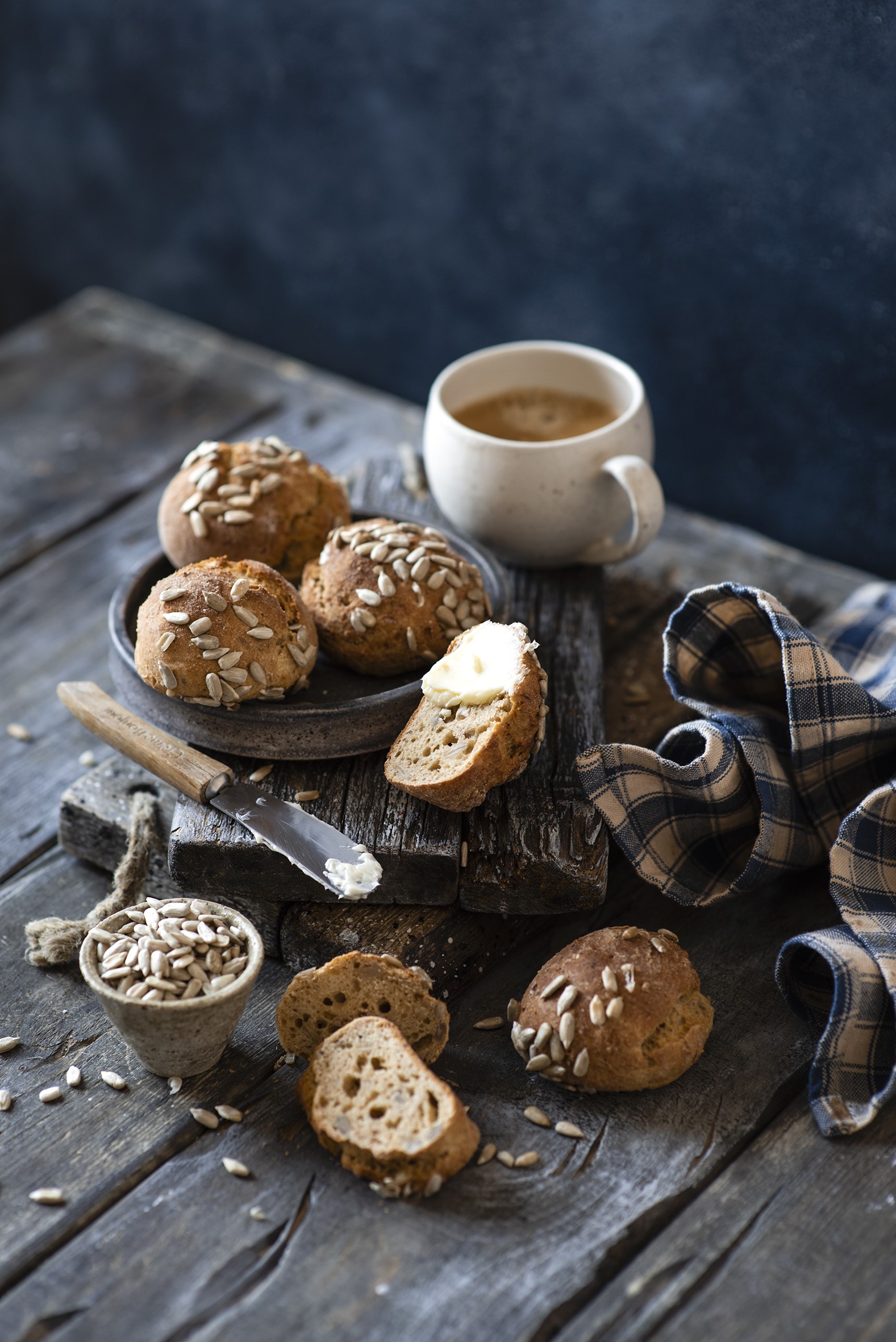 Coffee and sunflower seed buns on wooden table HD Phone Wallpaper