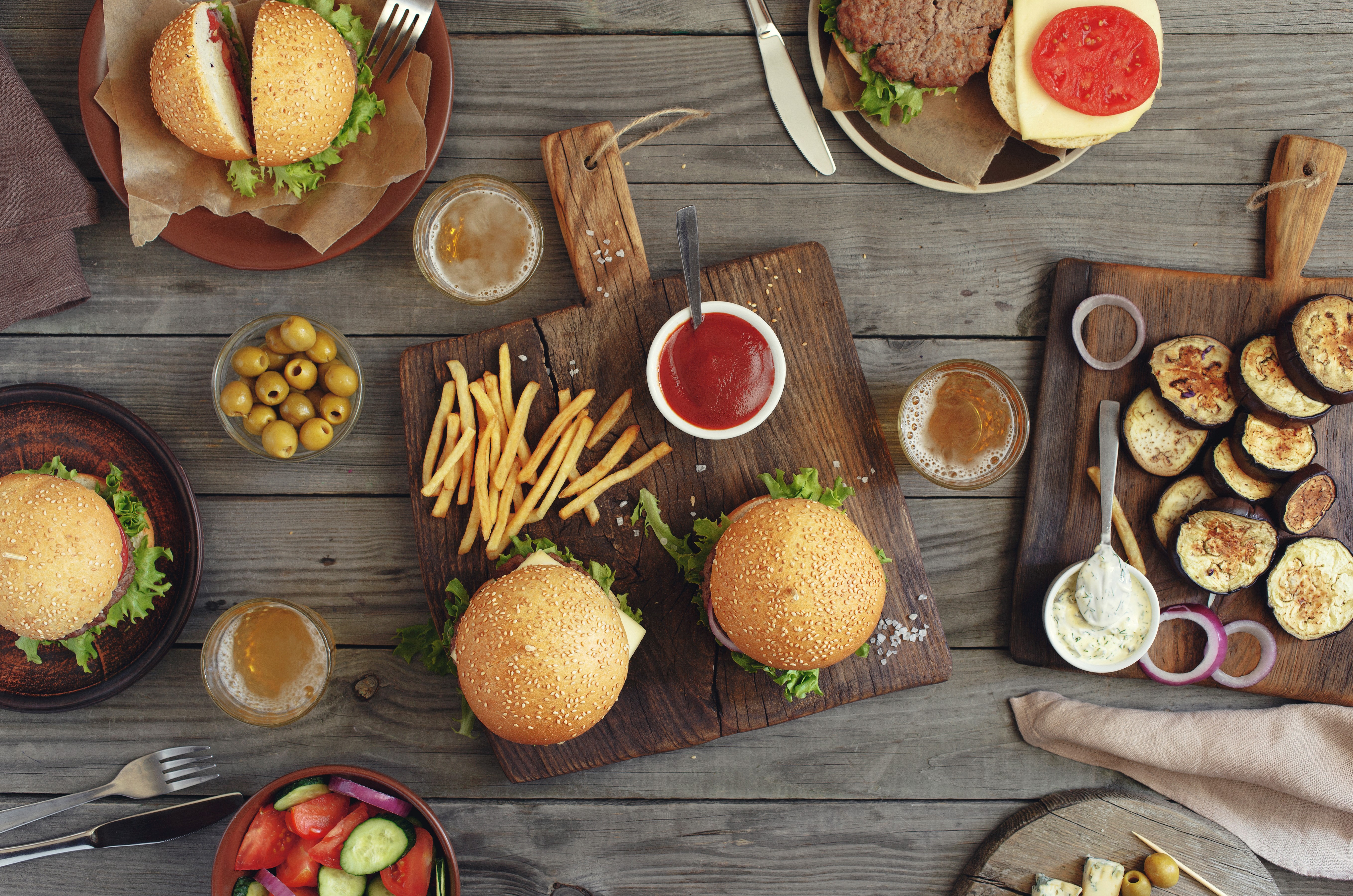 Hamburger meal with fries, olives, salad, and beer HD Wallpaper