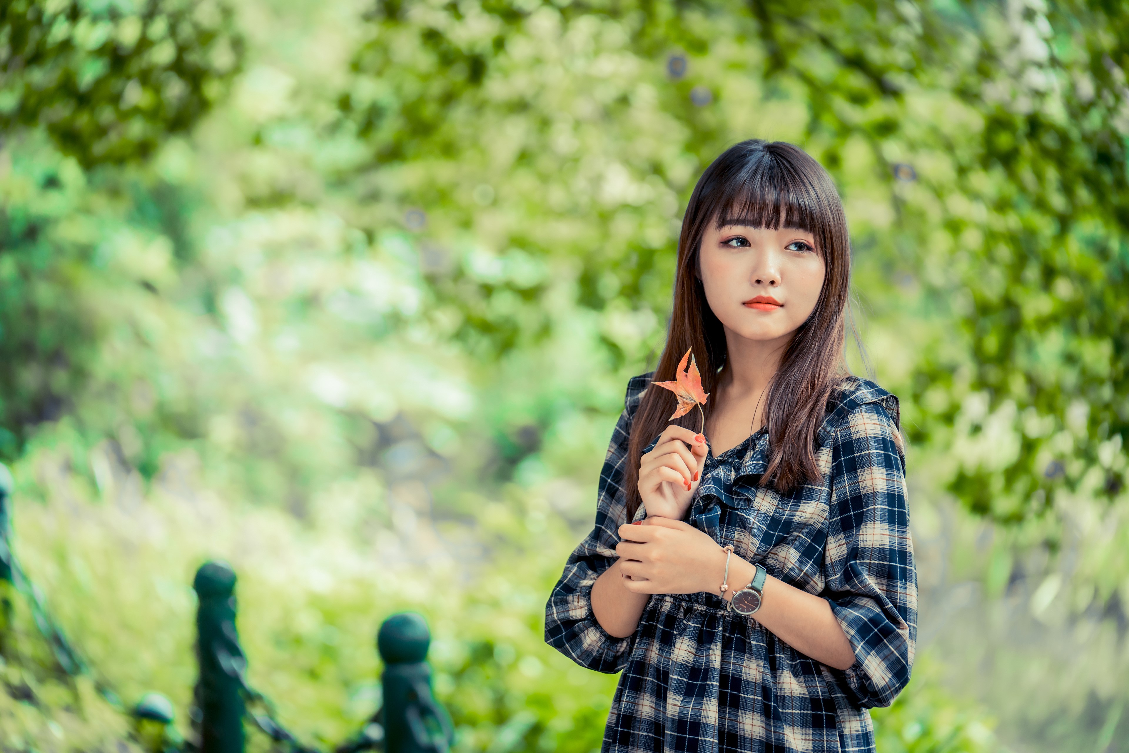 Asian girl with brown hair holding a leaf HD Wallpaper