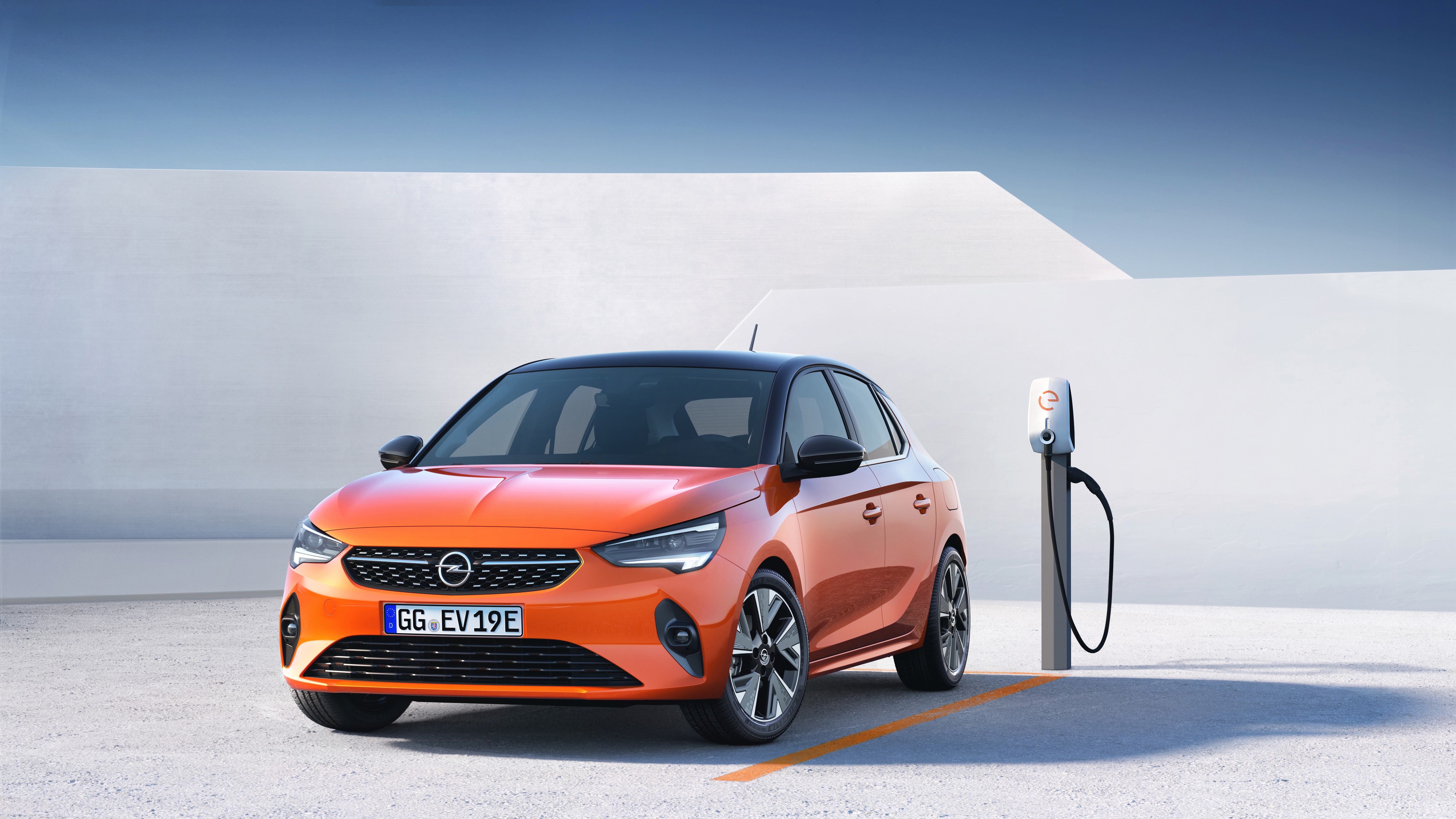 Orange Opel Corsa E electric car at charging station HD Wallpaper