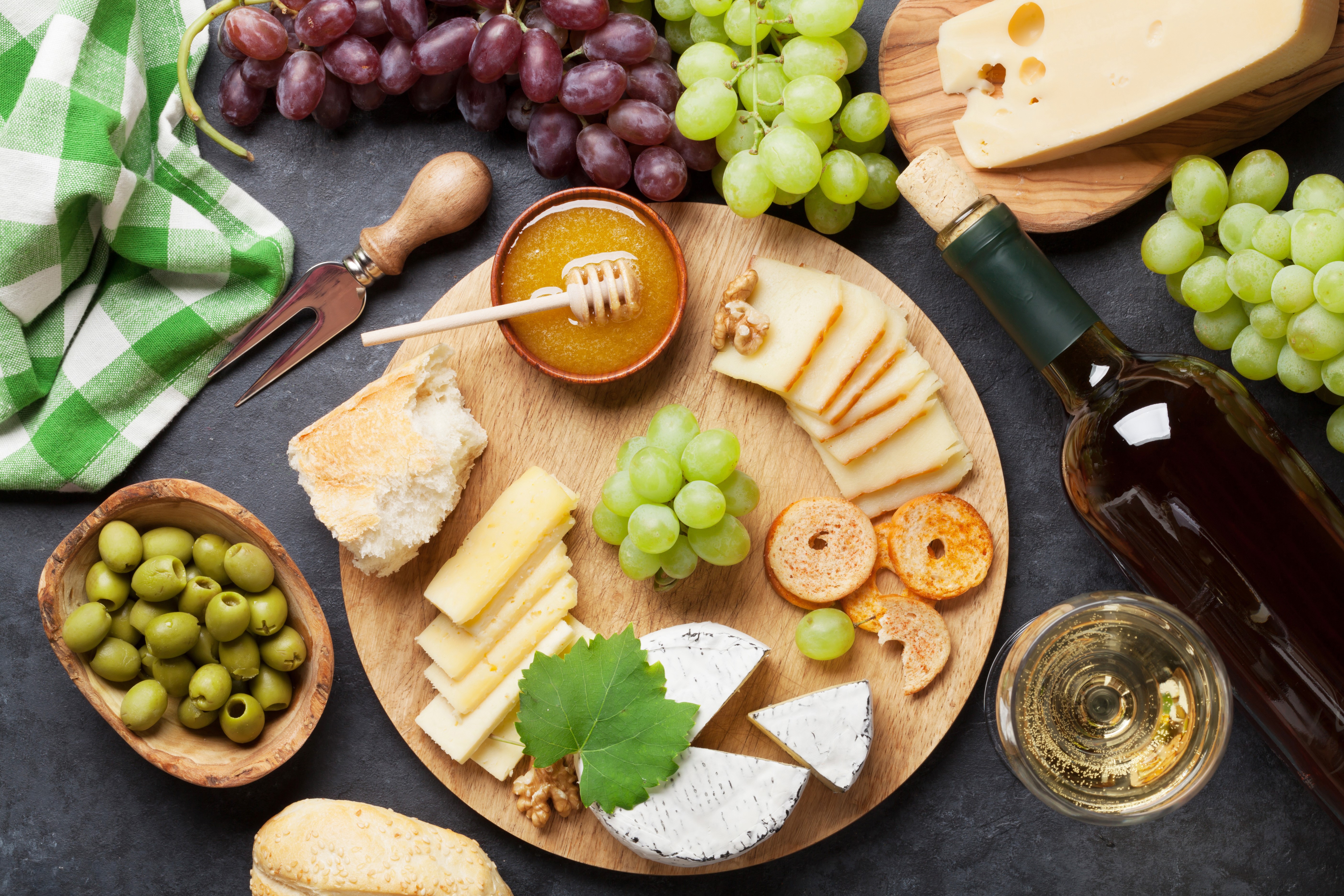 Cheese, Grapes, Olives, Honey, and Wine on a Cutting Board HD Wallpaper