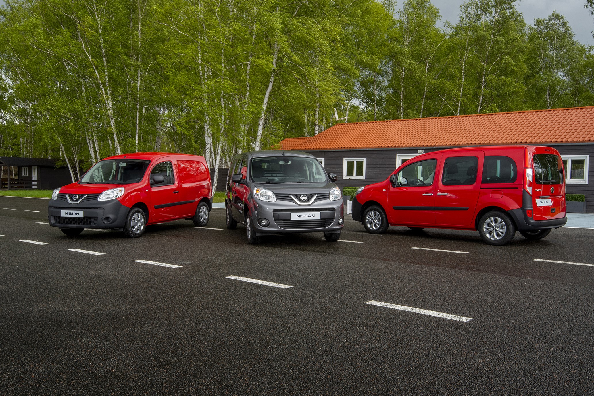 Three Nissan NV250 vans in metallic colors HD Wallpaper