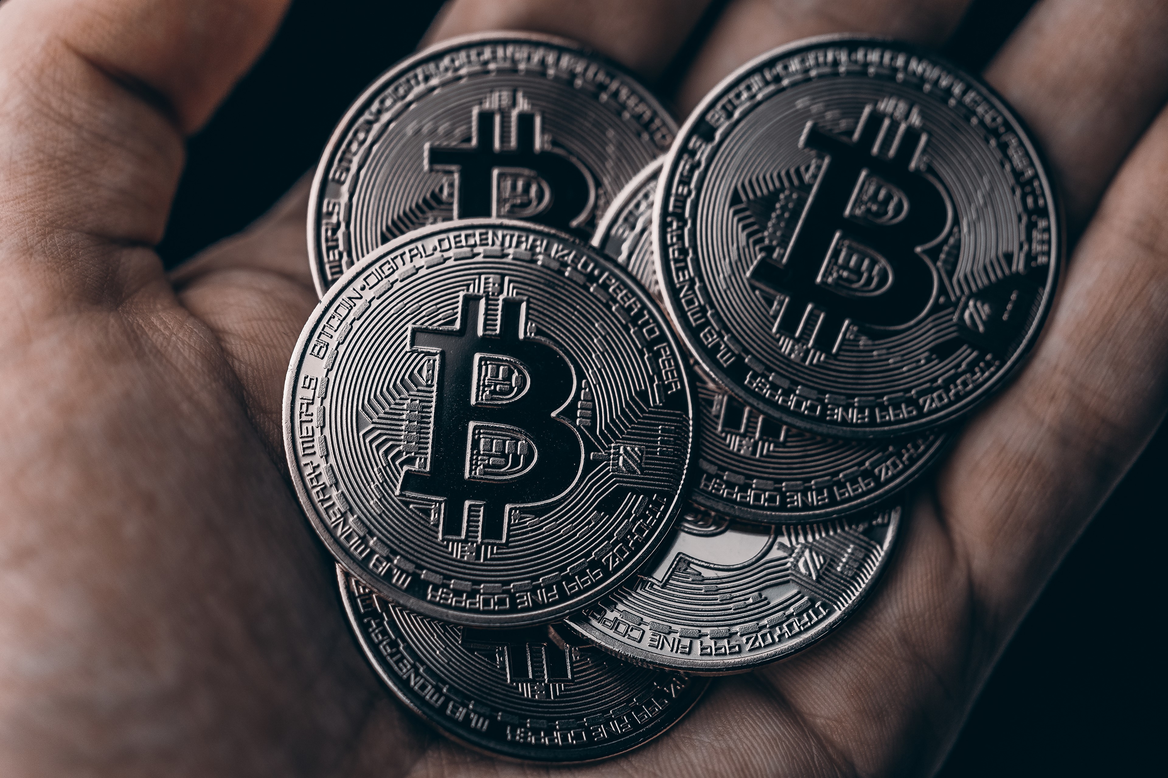 Bitcoin coins in hand HD Wallpaper