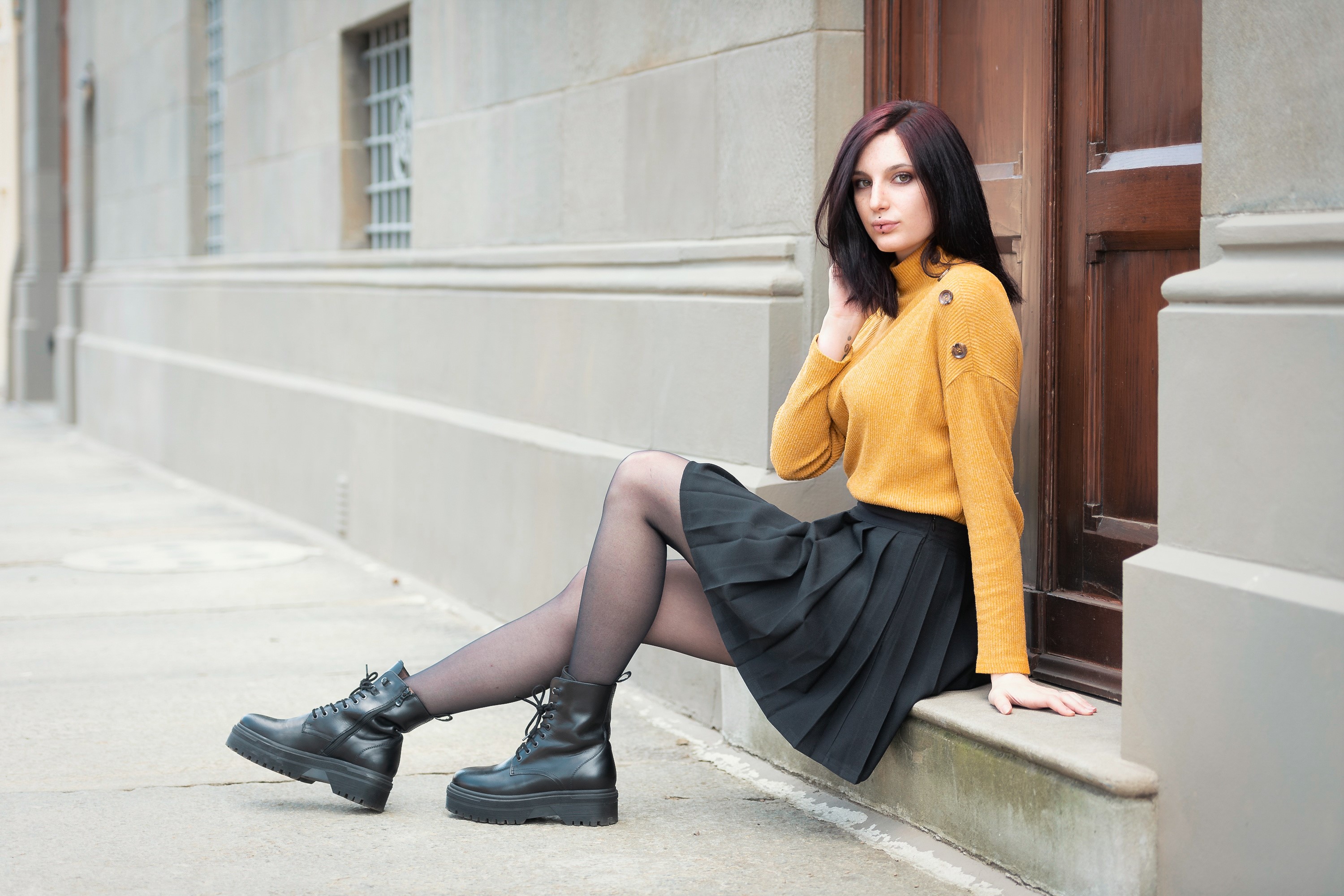 Elisa sitting on a step wearing a sweater and skirt HD Wallpaper