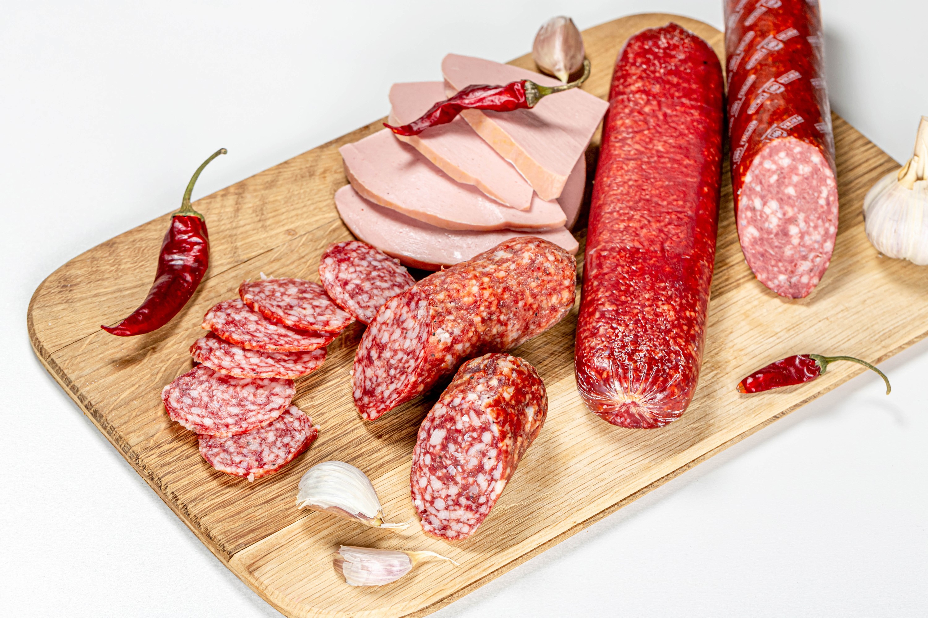 Sausage, Chili Peppers, and Garlic on a Cutting Board HD Wallpaper