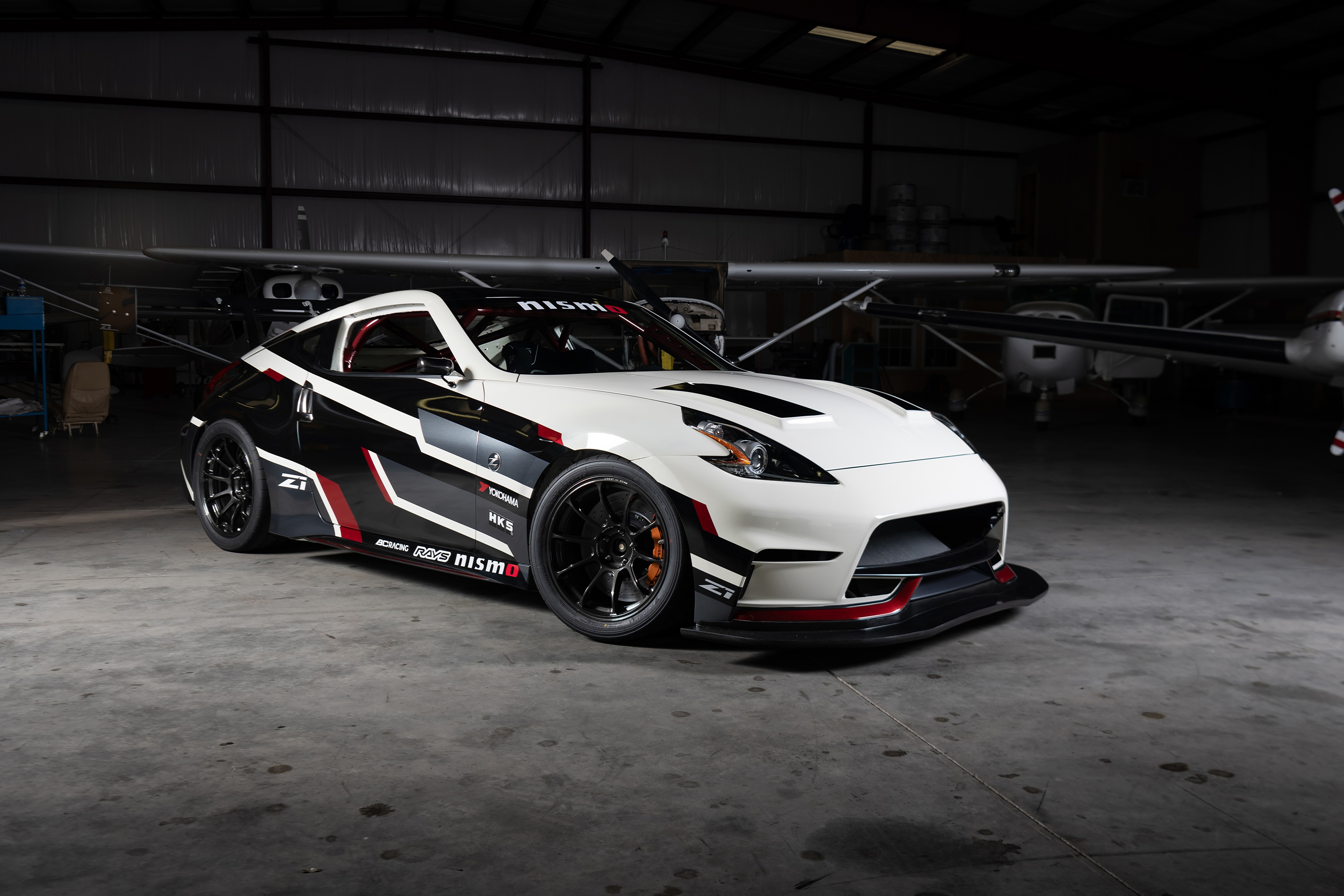 White and Black Nissan 370Z Nismo in Hangar HD Wallpaper