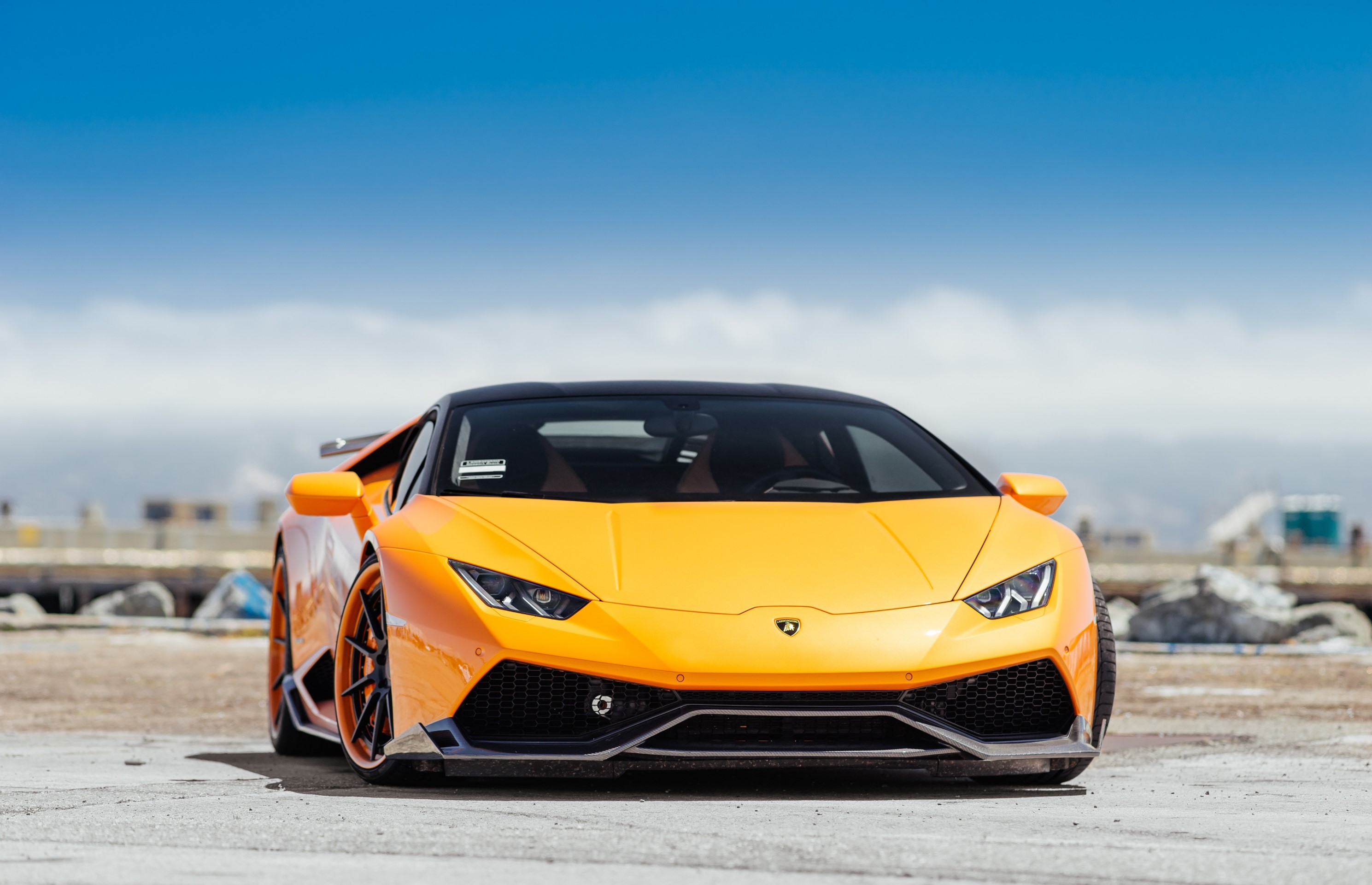Orange Lamborghini Huracan parked outdoors HD Wallpaper