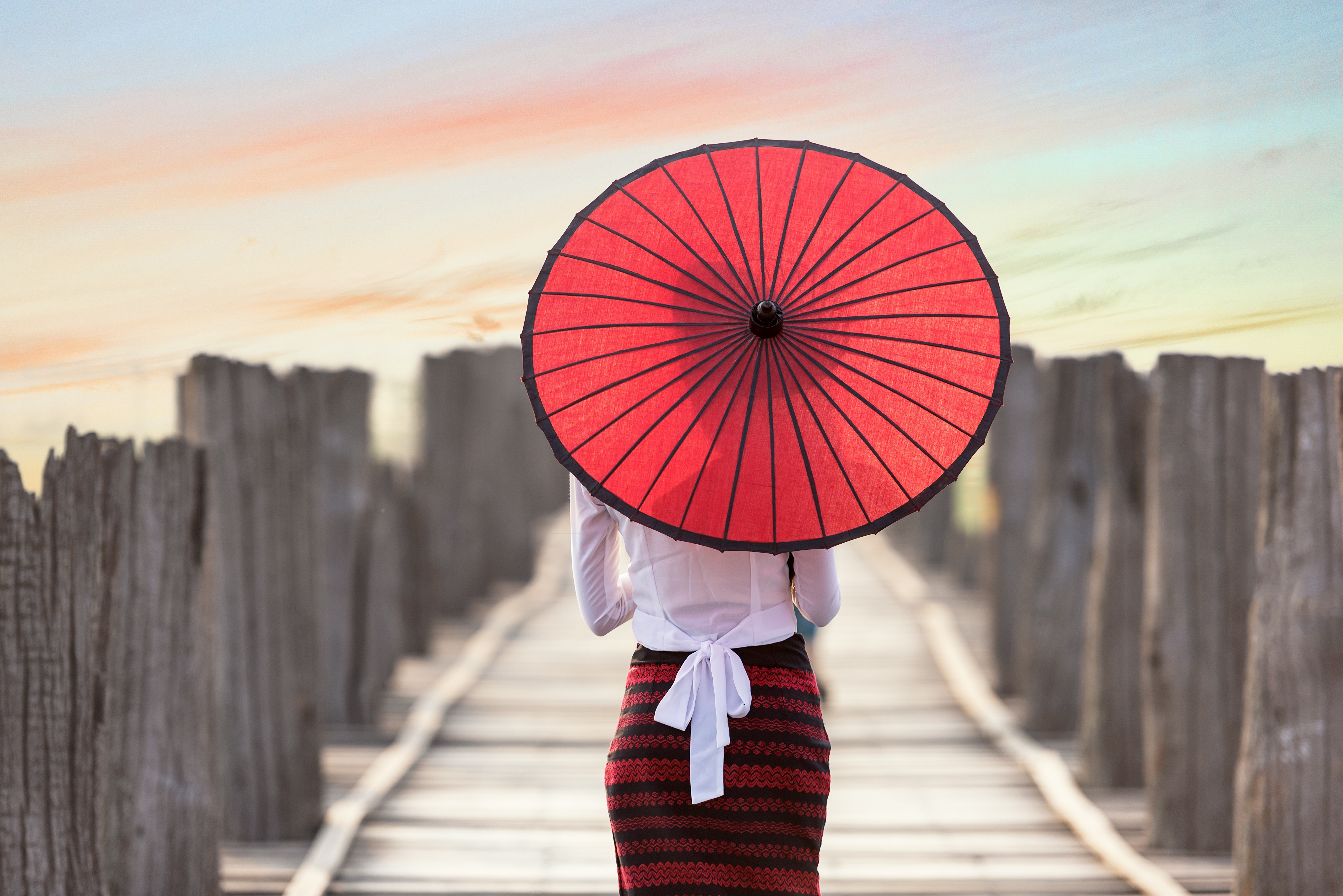 Woman with red umbrella on wooden bridge HD Wallpaper