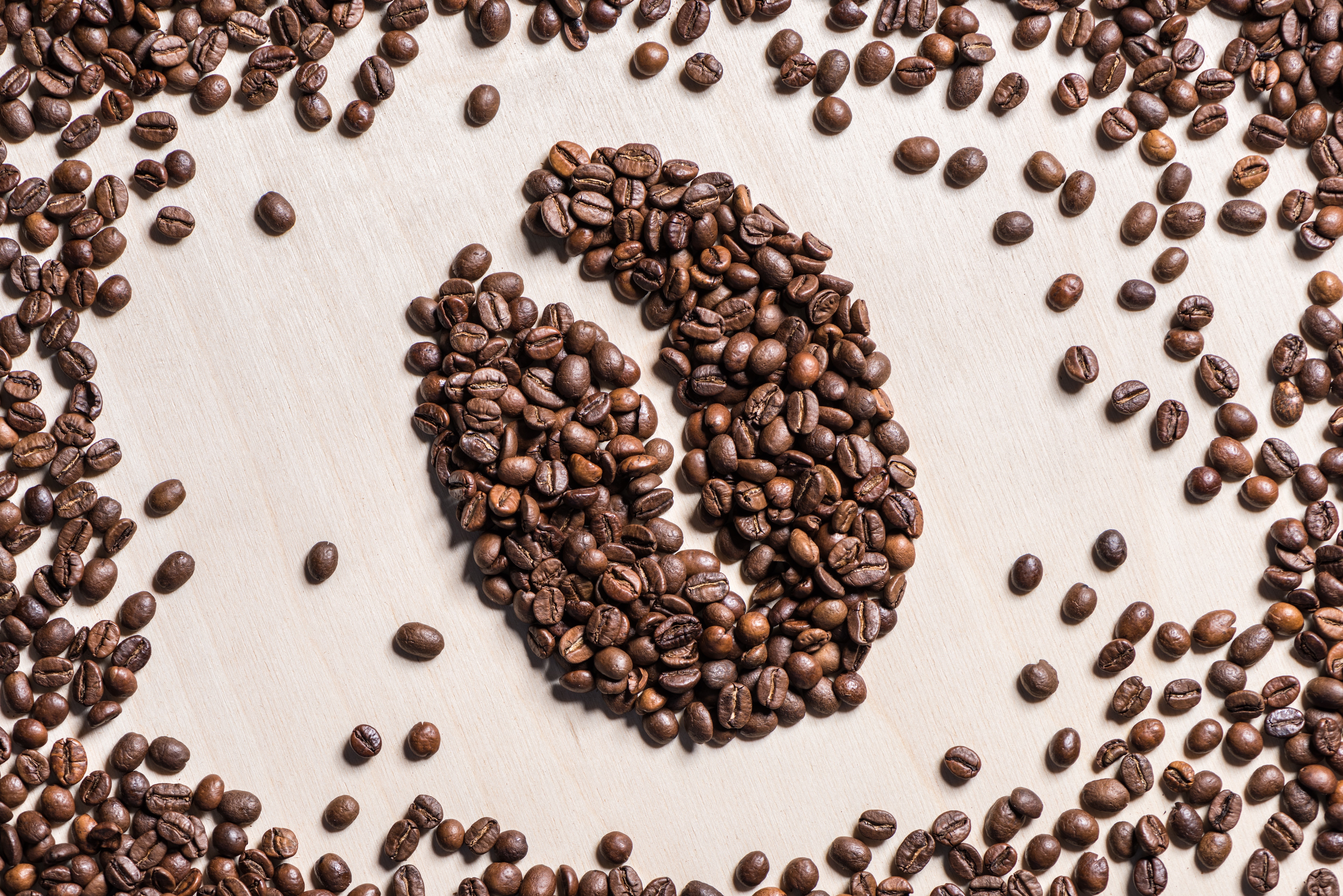 Coffee beans arranged in a coffee bean shape HD Wallpaper