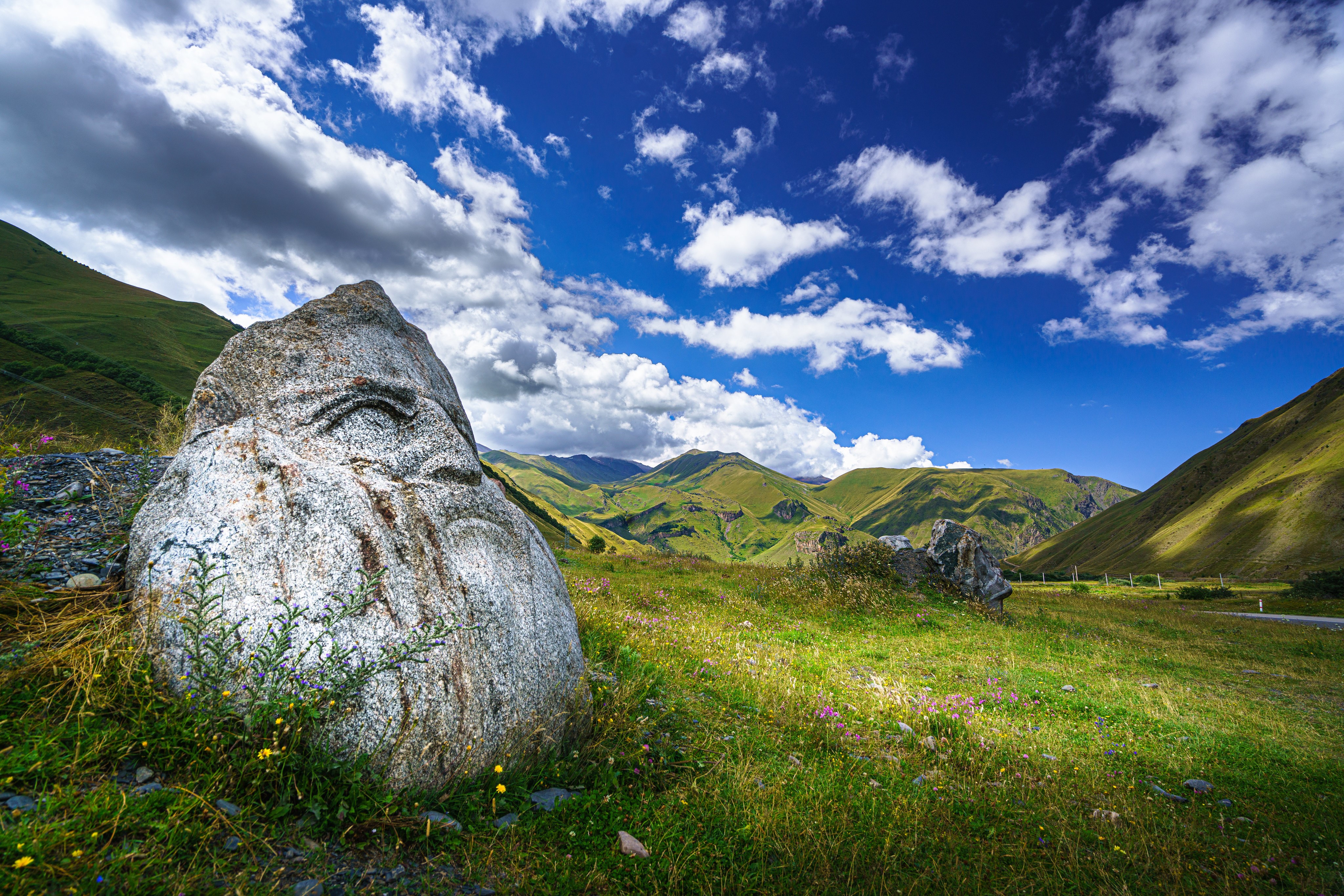 Stone with carved face in Upper Svaneti, Georgia HD Wallpaper