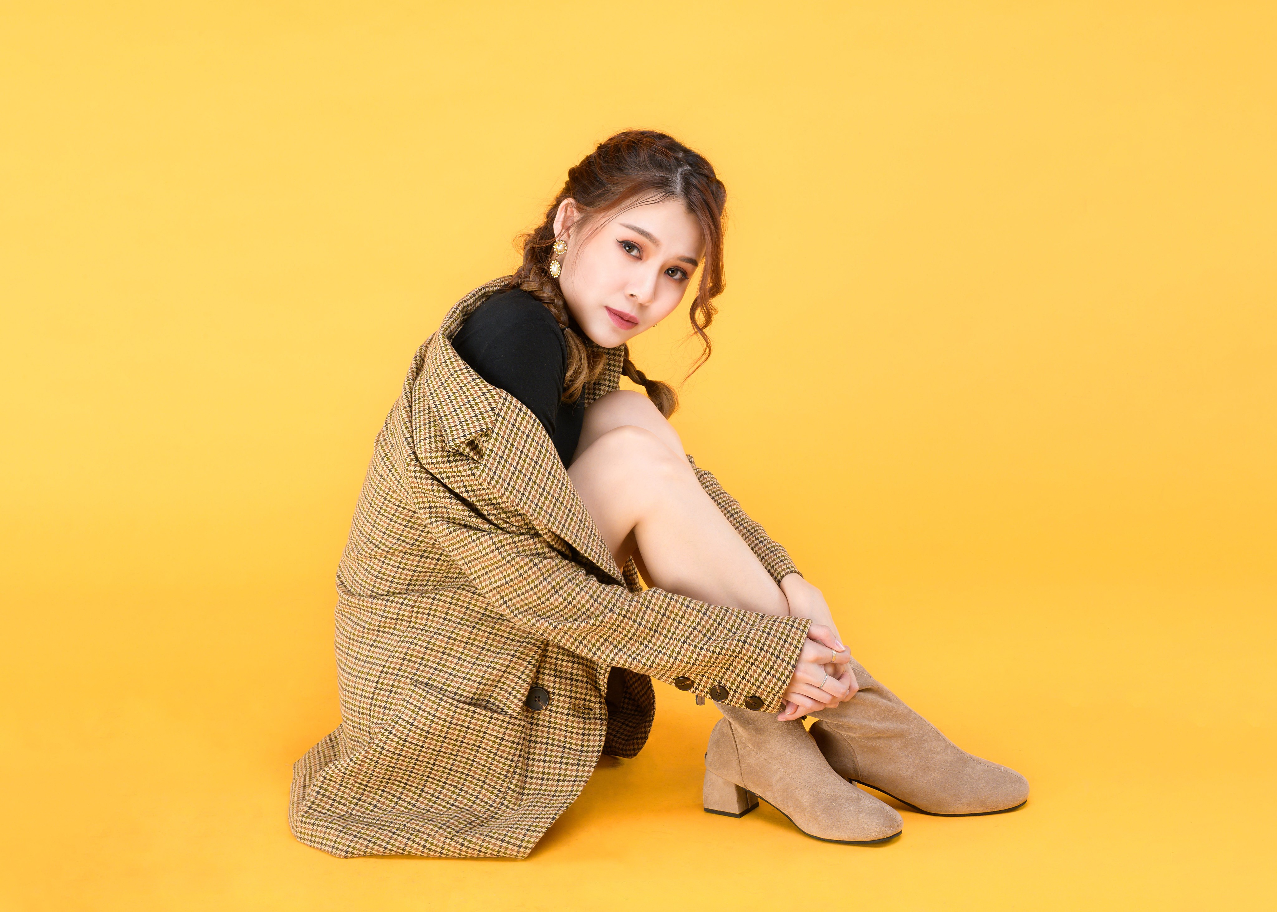 Asian woman sitting on yellow background HD Wallpaper