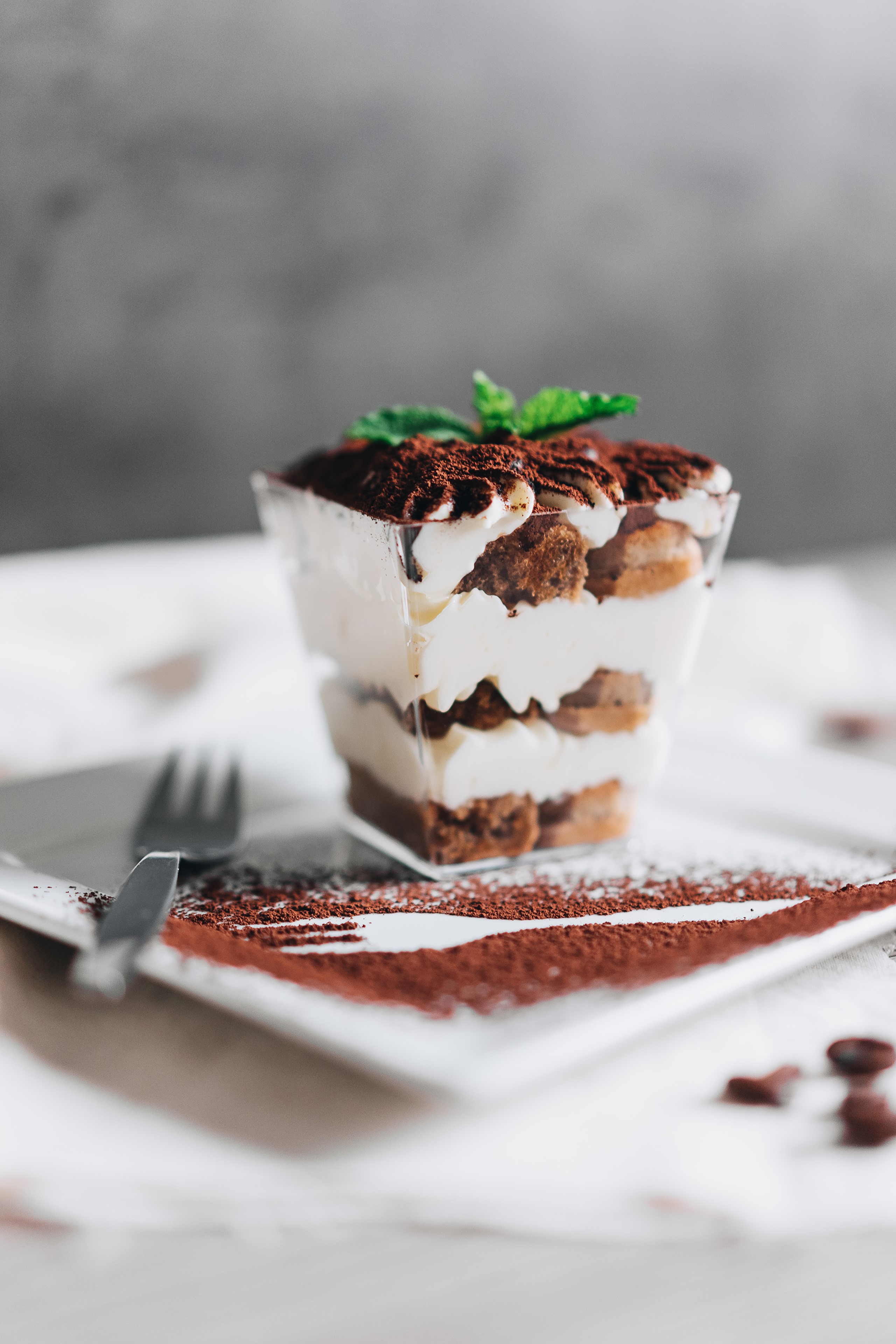 Tiramisu dessert in a glass with cocoa powder and mint HD Phone Wallpaper