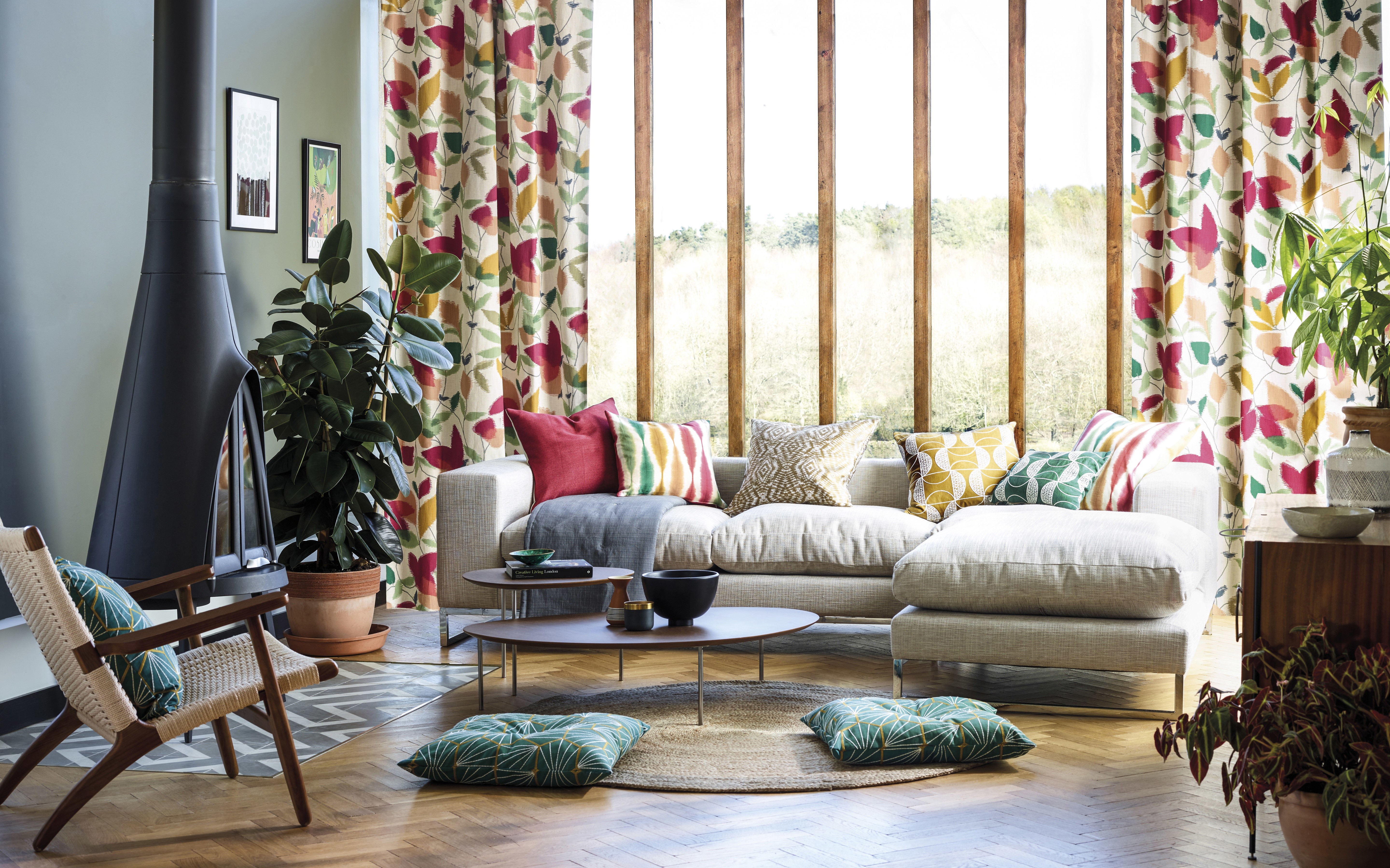 Living room with fireplace, sofa, and patterned curtains HD Wallpaper