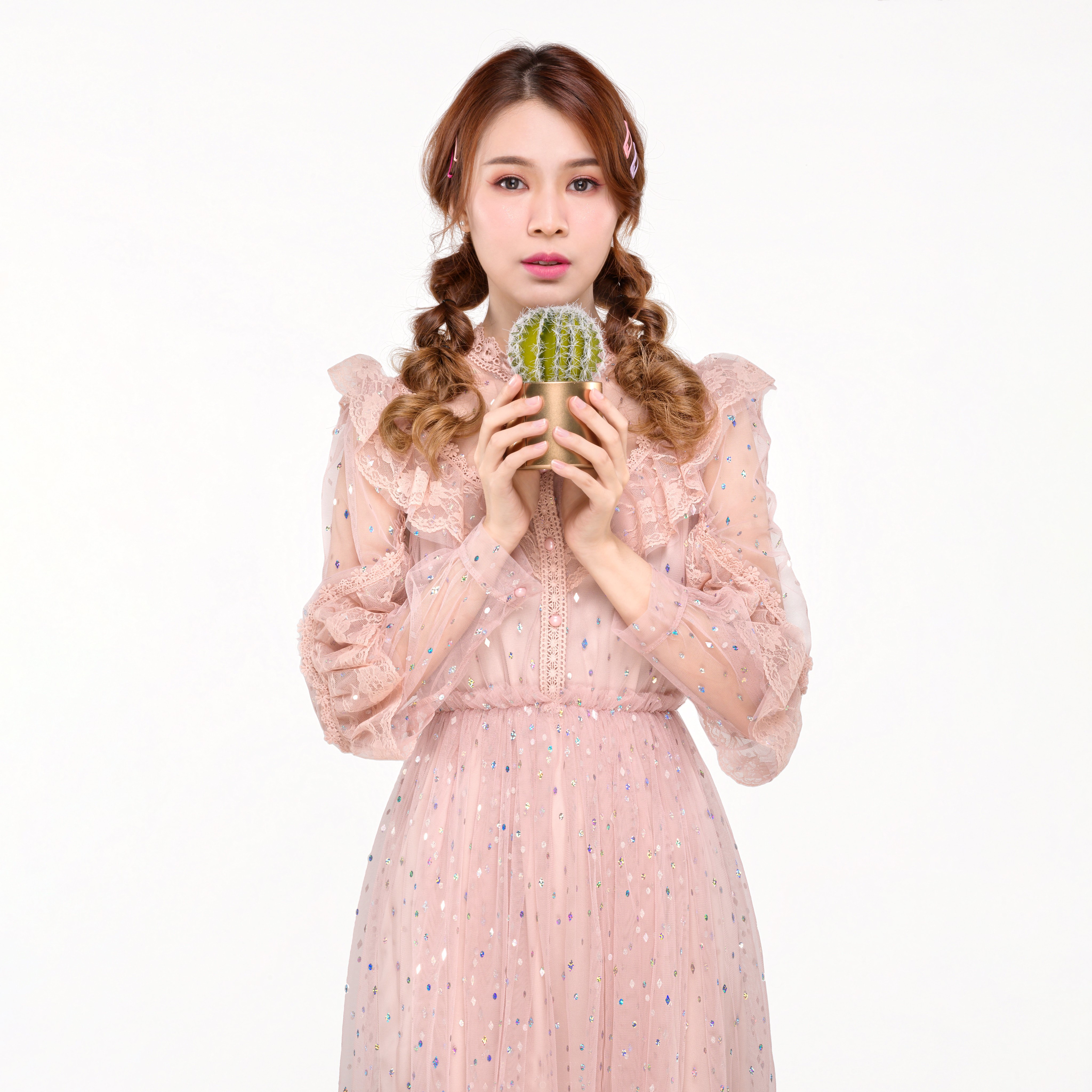 Asian woman with braided hair holding a cactus HD Wallpaper