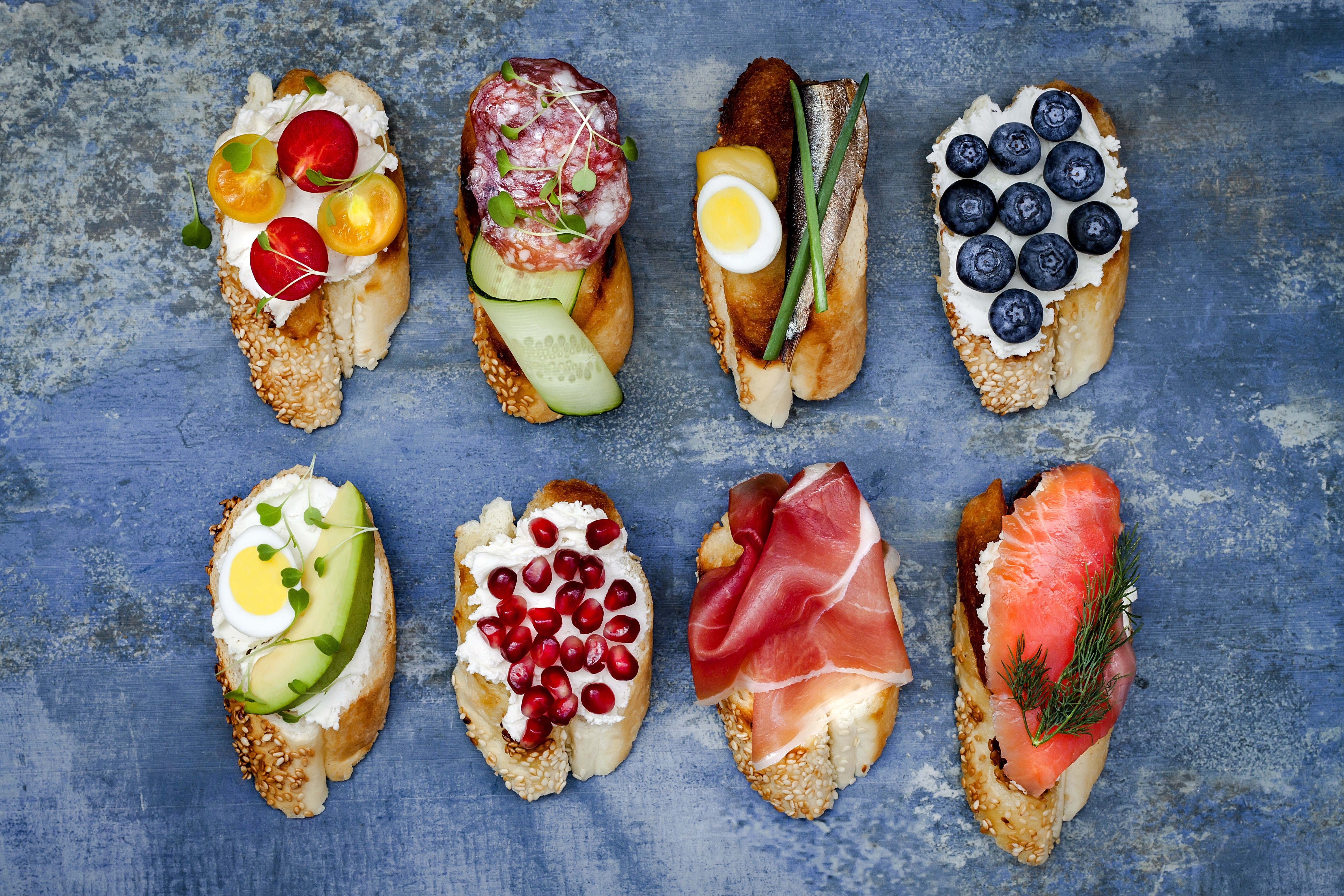 Assortment of Bruschetta with Various Toppings HD Wallpaper
