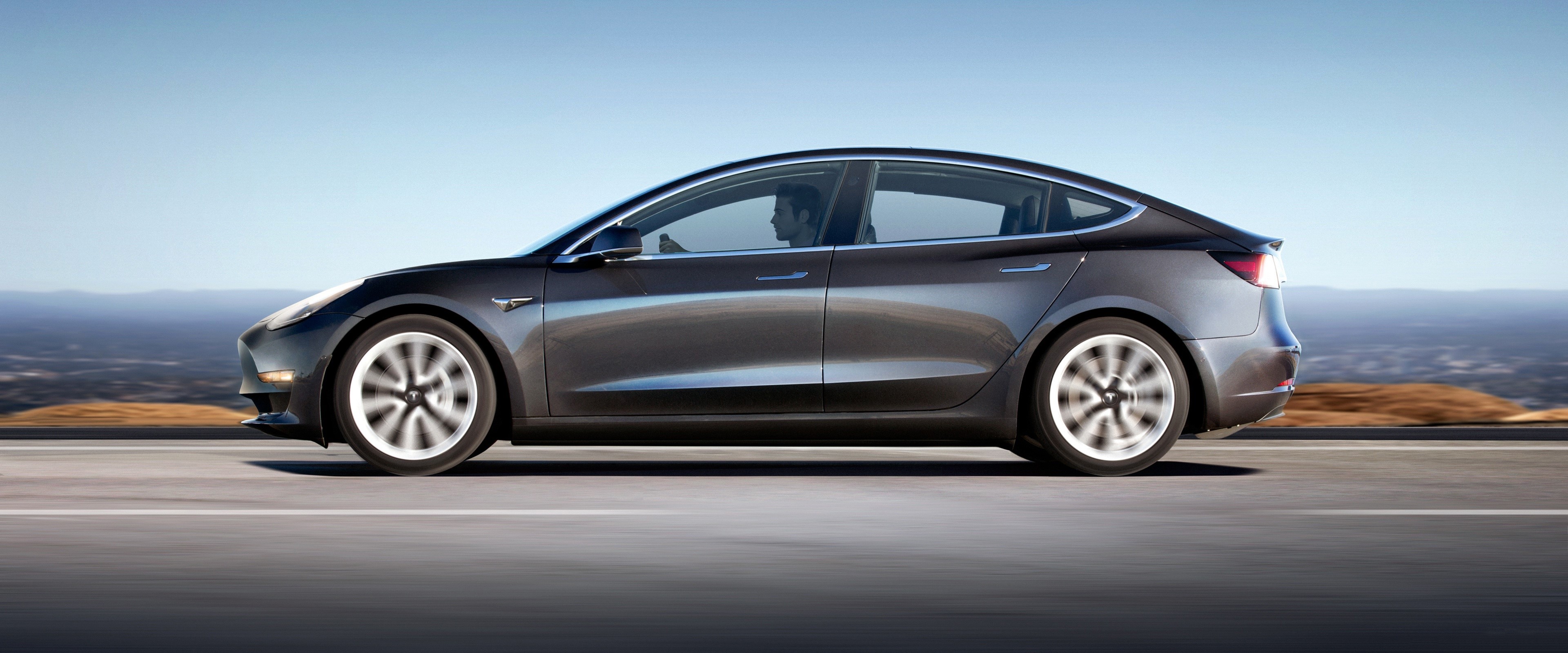 4K Tesla Model 3 Driving on Road HD Wallpaper