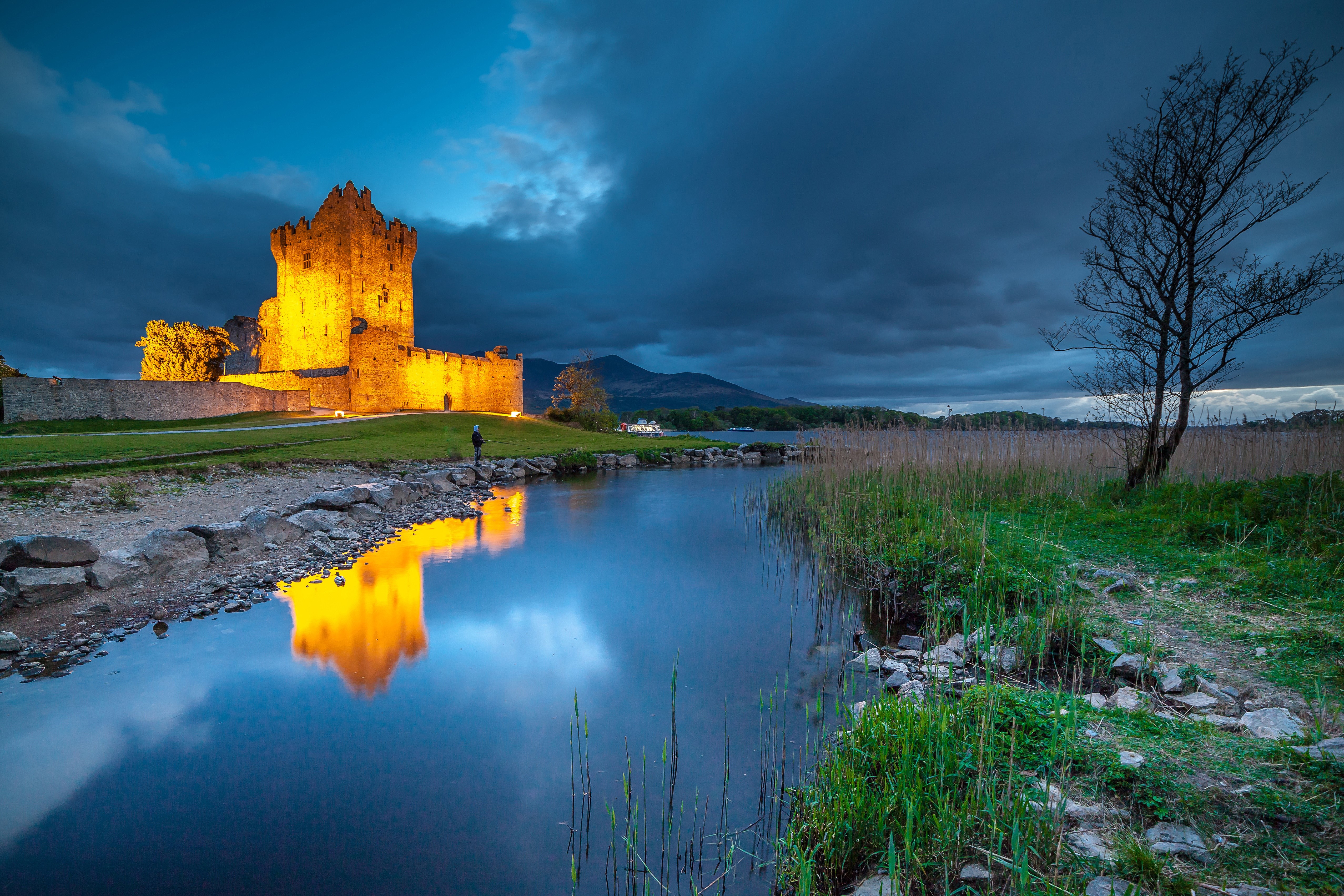 Ross Castle illuminated at dusk on Lough Leane, Ireland HD Wallpaper