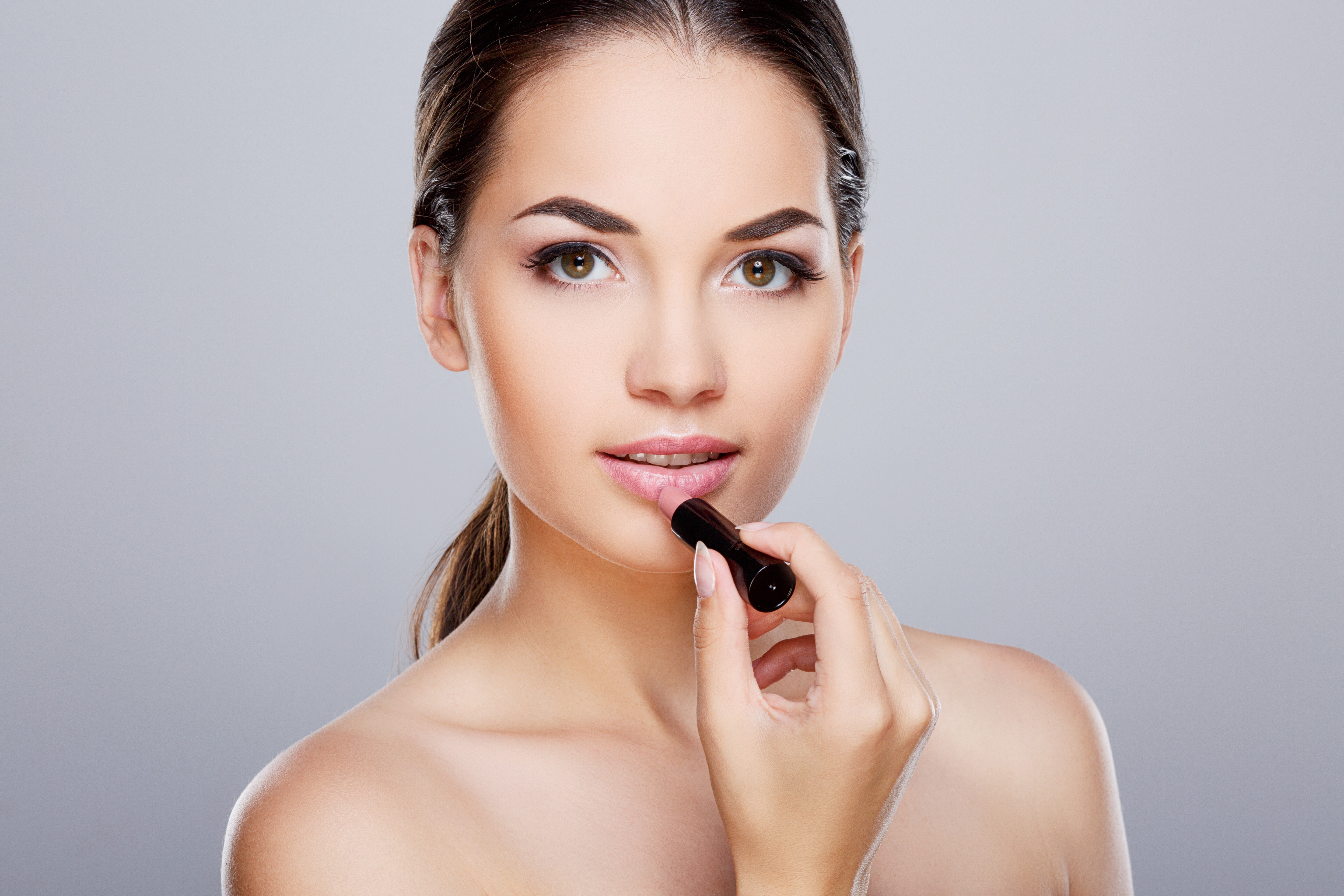 Model applying lipstick HD Wallpaper