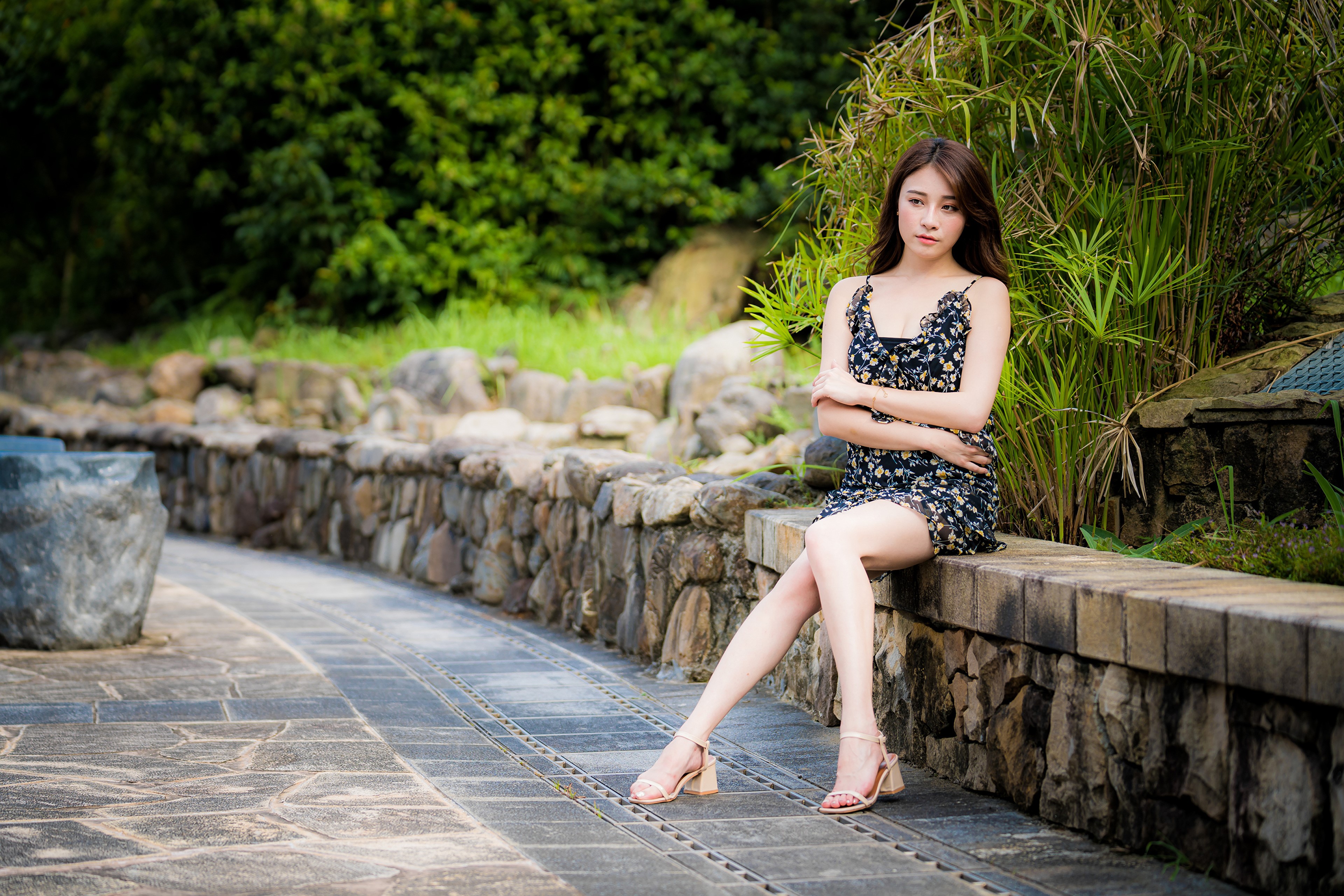 4K Asian Woman Sitting on Stone Wall HD Wallpaper