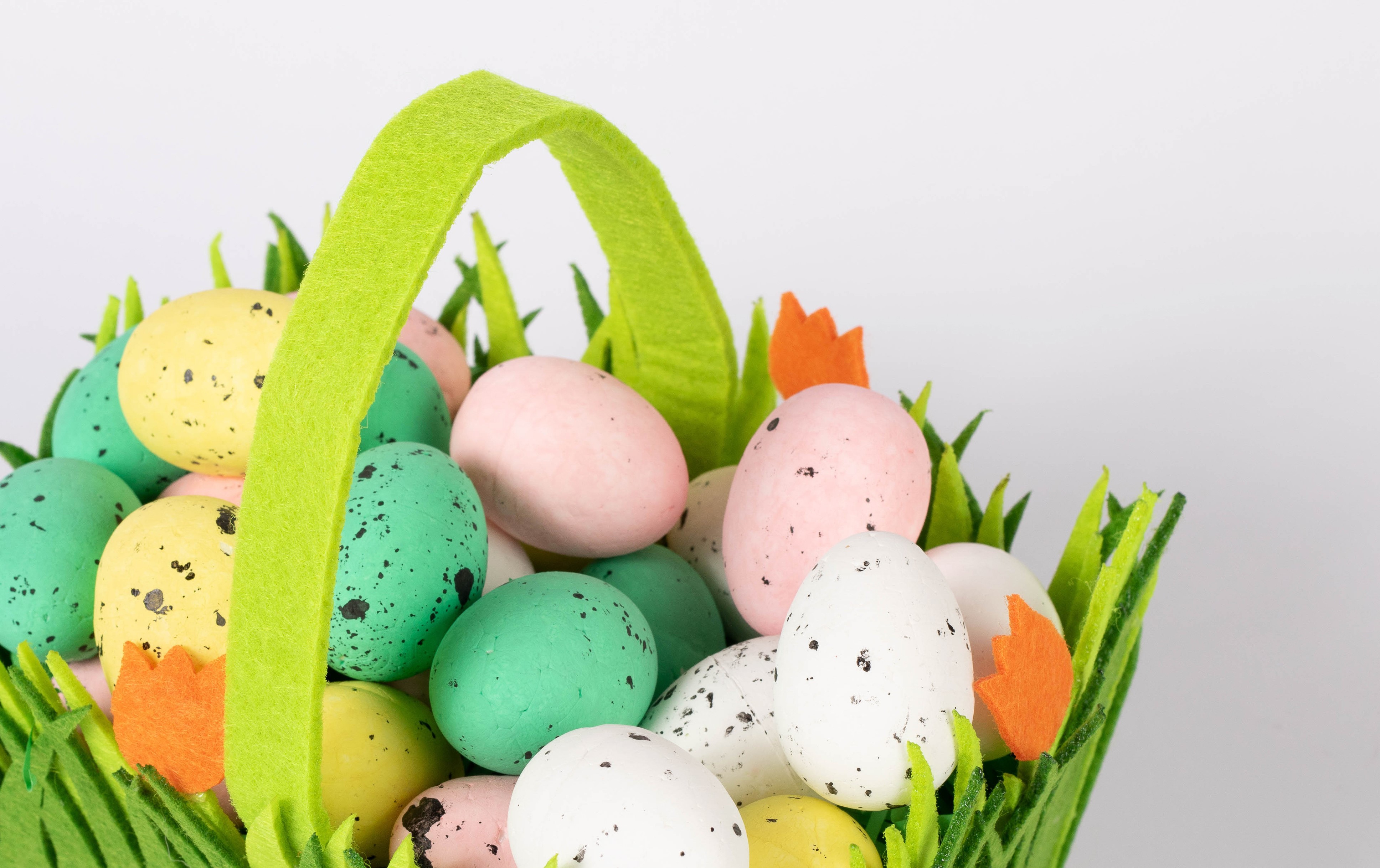 Easter basket with colorful eggs and green grass HD Wallpaper