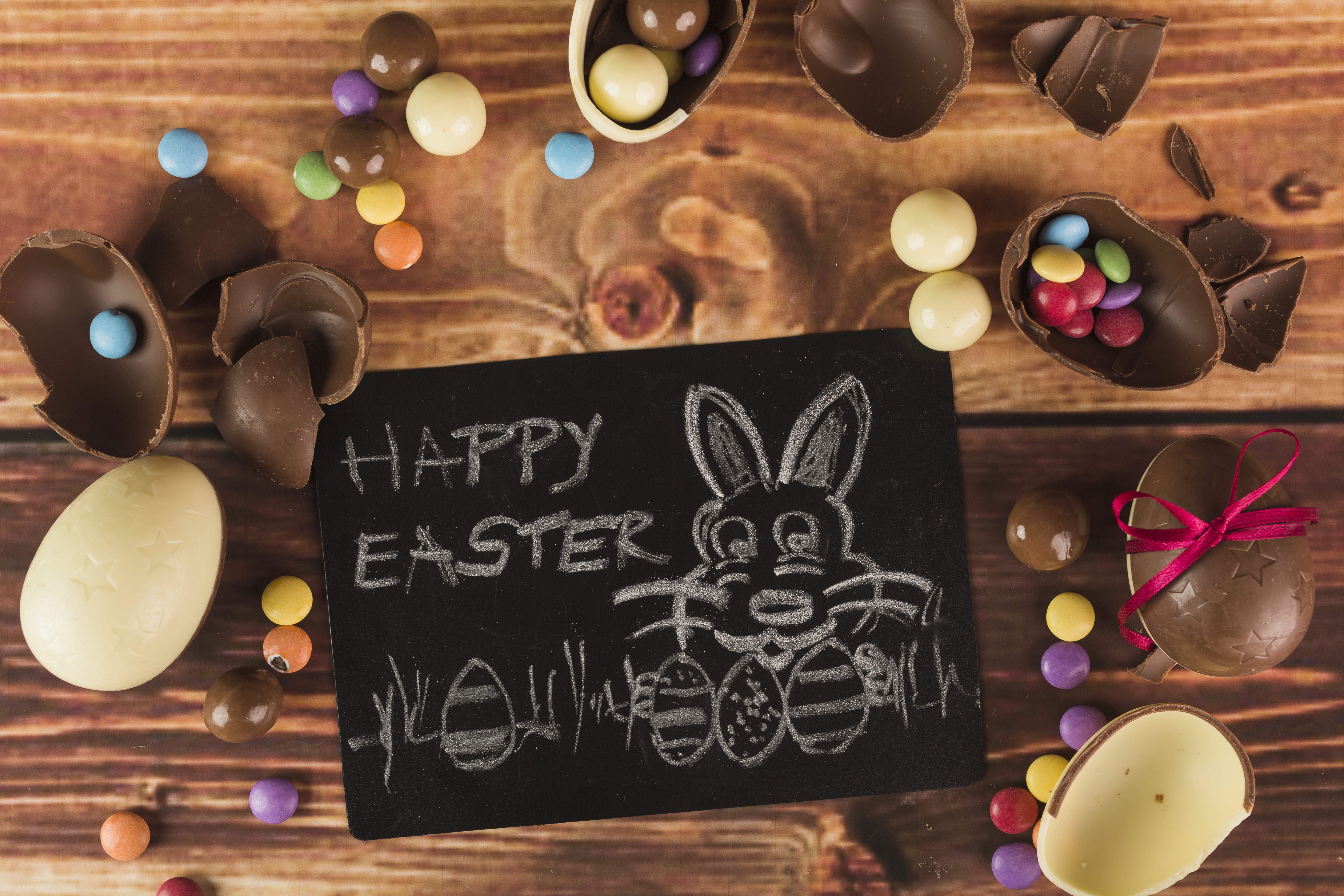 Easter chocolate eggs and candies on wood HD Wallpaper