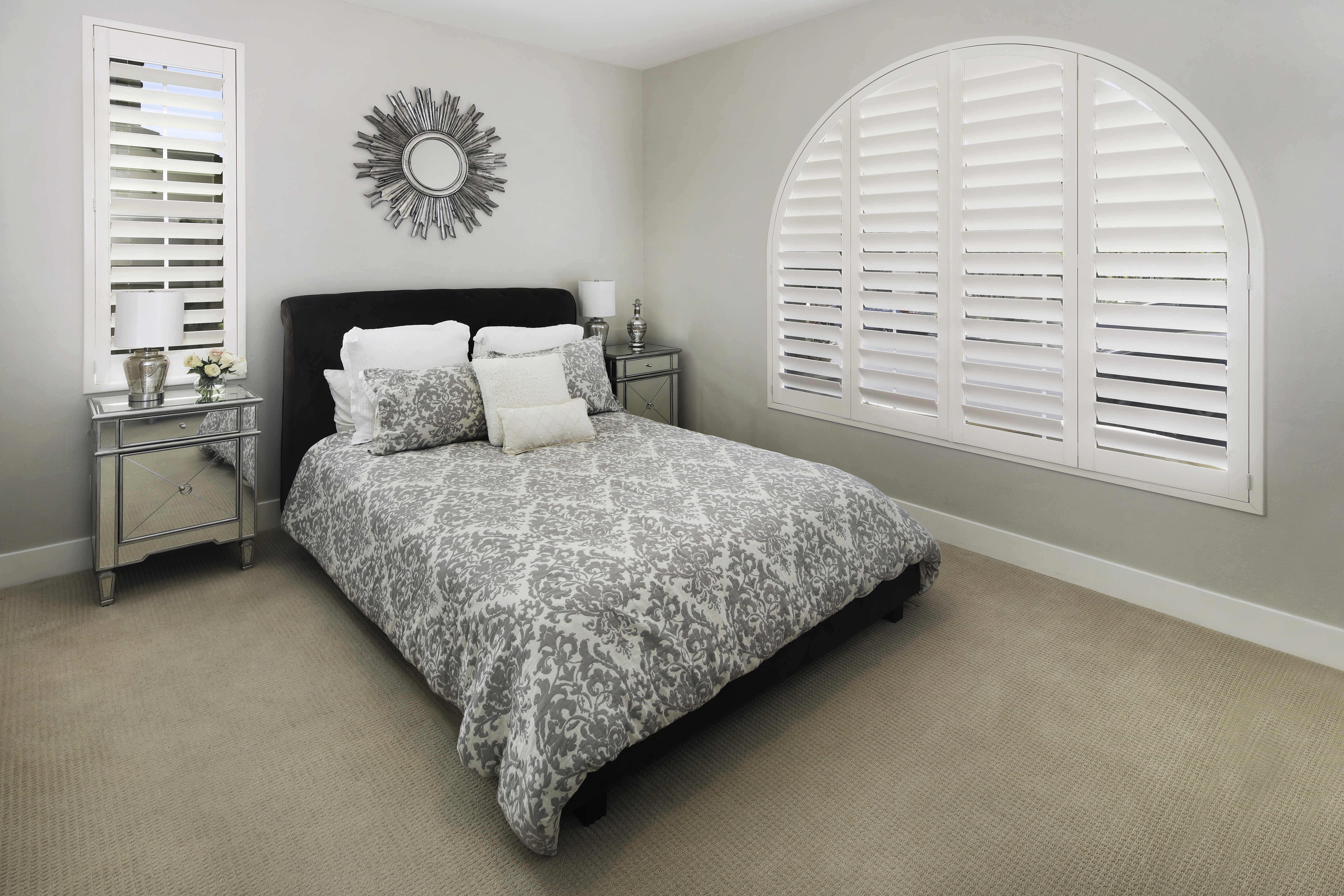 Bedroom with bed, pillows, and arched window HD Wallpaper