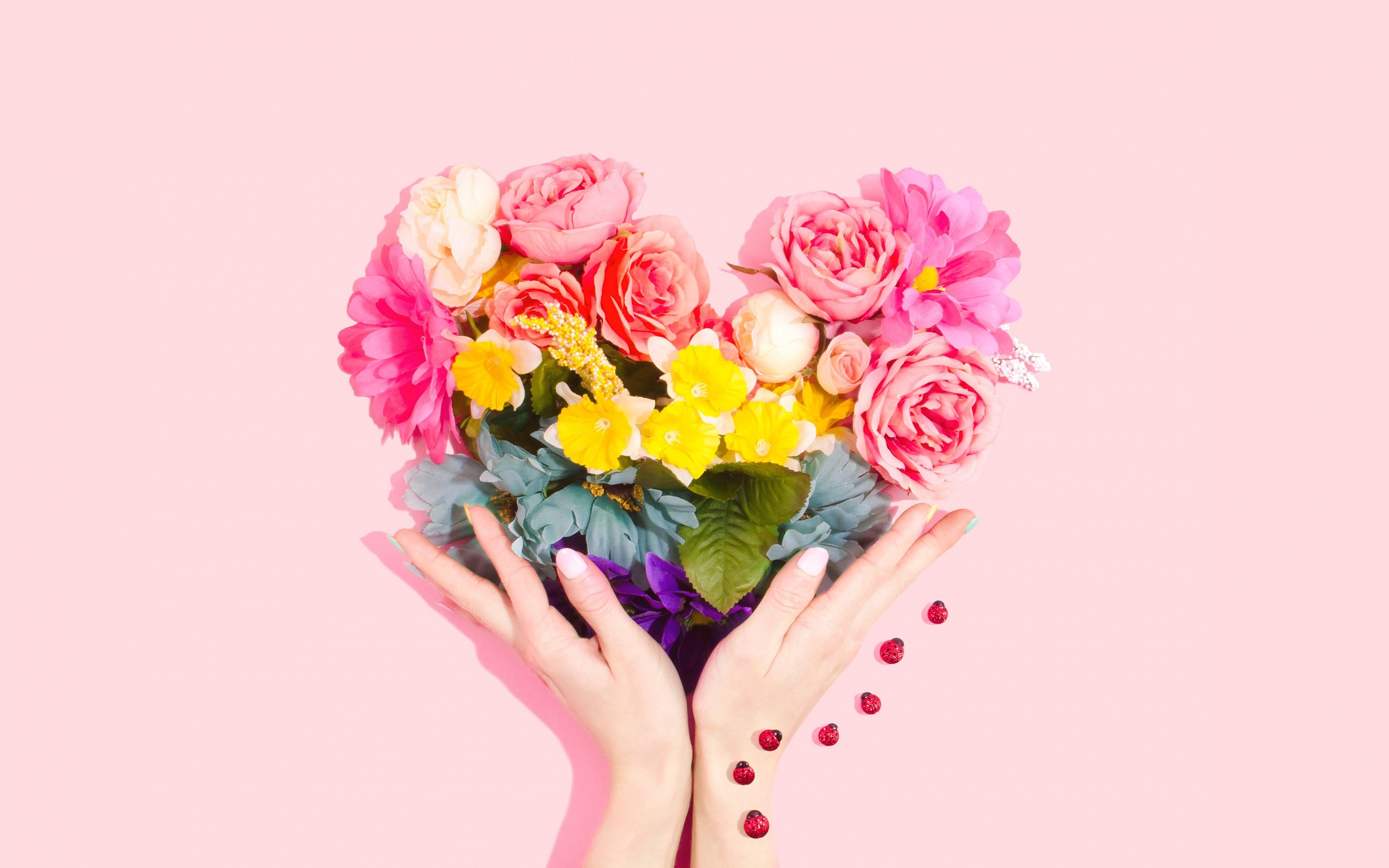 Heart-shaped flower bouquet held by hands with ladybugs HD Wallpaper